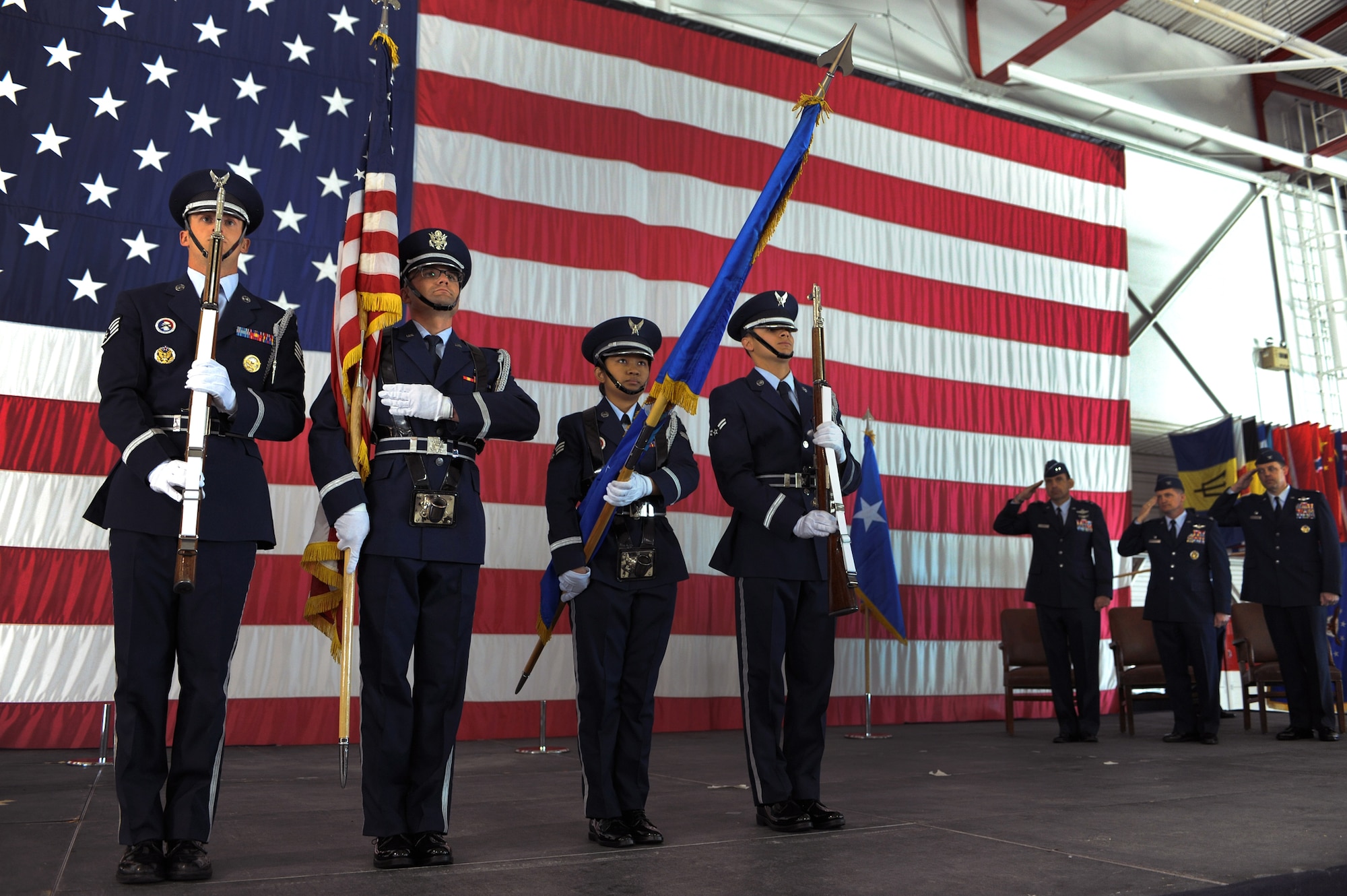 NELLIS AIR FORCE BASE, Nev -- The Nellis Honor Guard presents the colors during the national anthem at the 99th Air Base Wing change of command ceremony held in the Thunderbird hangar March 12. (U.S. Air Force photo by Tech. Sgt. Michael R. Holzworth)
