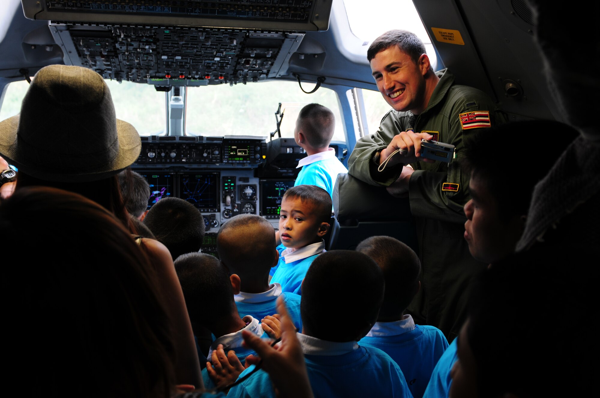First Lt. Christopher Poponi gives local Thai students the opportunity to sit in the cockpit of a C-17 Globemaster III during the Cope Tiger 2010 open house held March 10 at Udon Thani Royal Thai Air Force Base, Thailand. Lieutenant Poponi is a pilot from the 204th Airlift Squadron at Joint Base Pearl Harbor Hickam, Hawaii.  (U.S. Air Force photo/Capt. Genieve David)