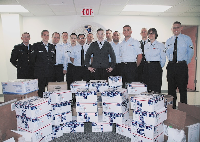 Air Force Sergeants Association President Staff Sgt. Mari Quiroga (center in sweater) and the members of Patrick Air Force Base Airman Leadership School class 10-3 packed 870 pounds of care package items worth $1,360 March 8. The supplies are to be shipped to 920th Rescue Wing Airmen currently deployed to Haiti in support of earthquake relief. The supplies were donated over the course of two weeks following a request from 920th Rescue Wing Command Chief Master Sgt. Jerry Delebreau. (U.S. Air Force photo/Senior Airman David Dobrydney)