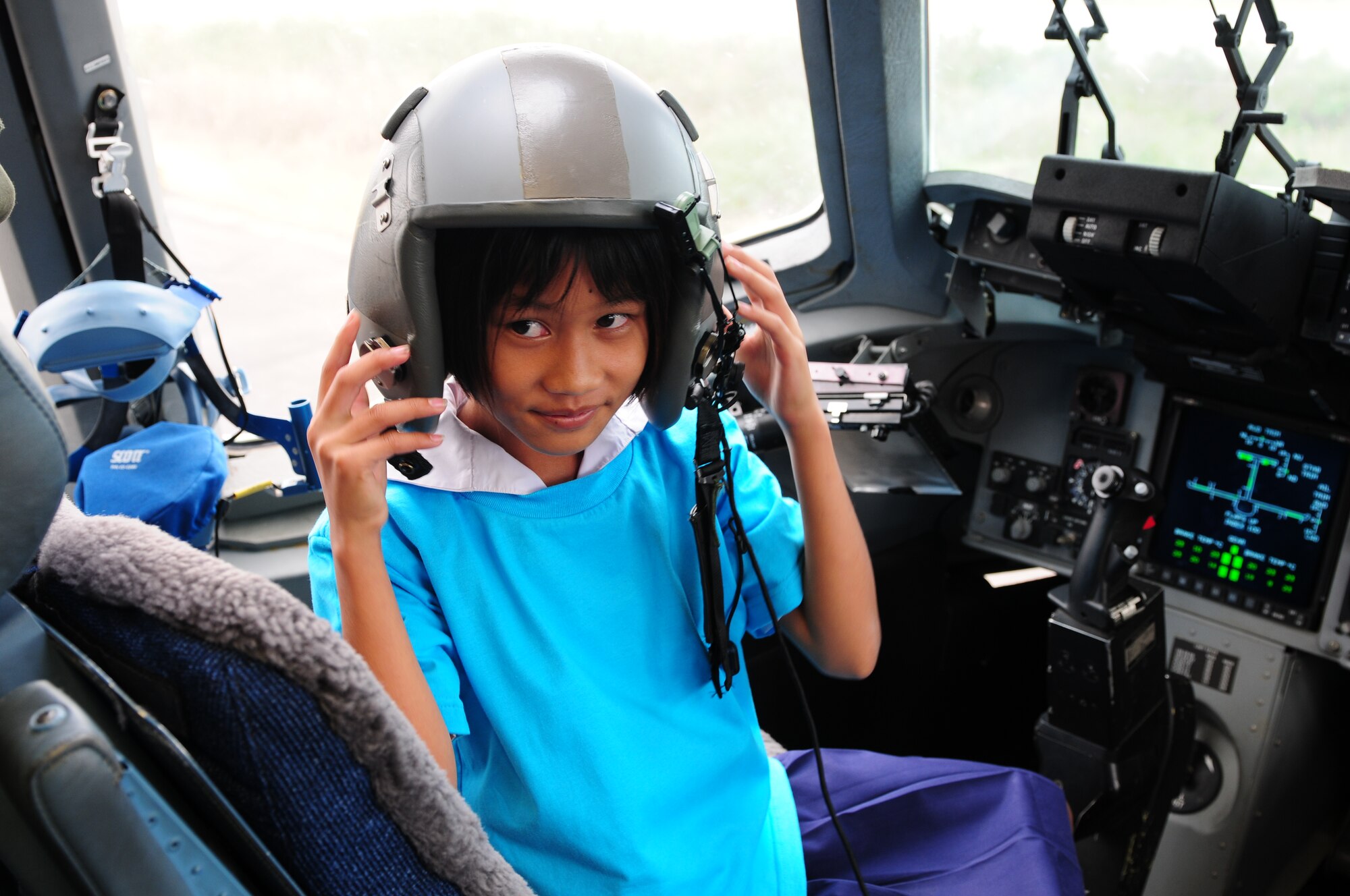 A Thai student enjoys sitting in the cockpit of the C-17 Globemaster III during the Cope Tiger 2010 open house held for more than 50 Thai students March 10 at Udon Thani Royal Thai Air Force Base, Thailand. (U.S. Air Force photo/Capt. Genieve David)