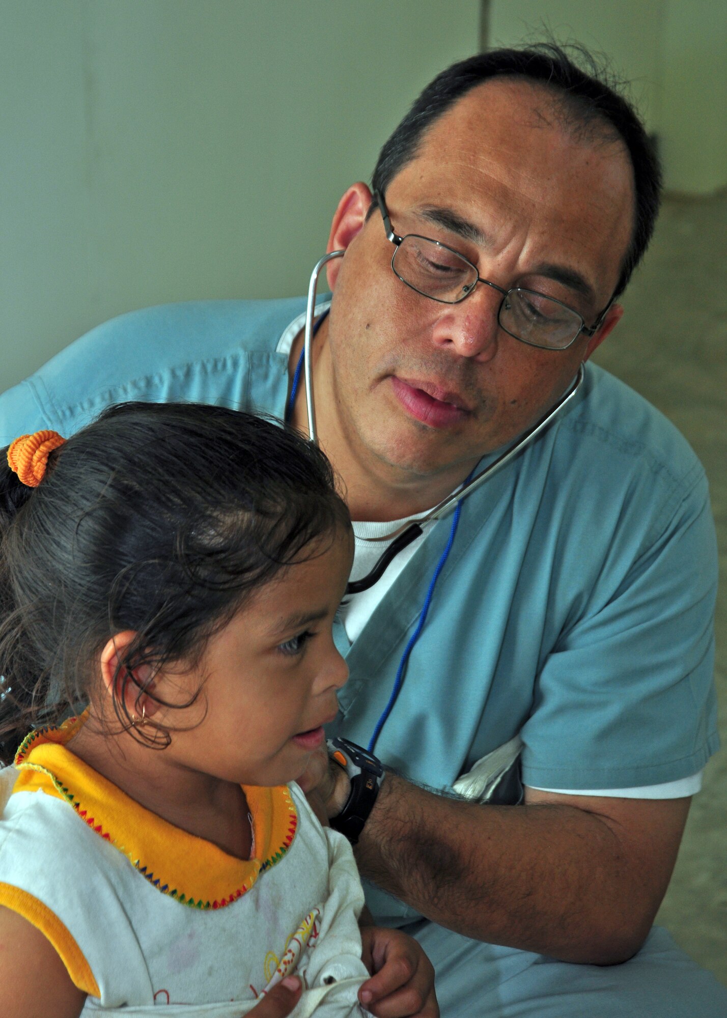 Dr. Guillermo Saenz checks a Belizean child for respiratory problems during medical readiness training exercise March 3, 2010, in Armenia, Belize. Doctor Saenz is assigned to the Joint Task Force-Bravo medical element. (U.S. Air Force photo/Staff Sgt. Bryan Franks)
