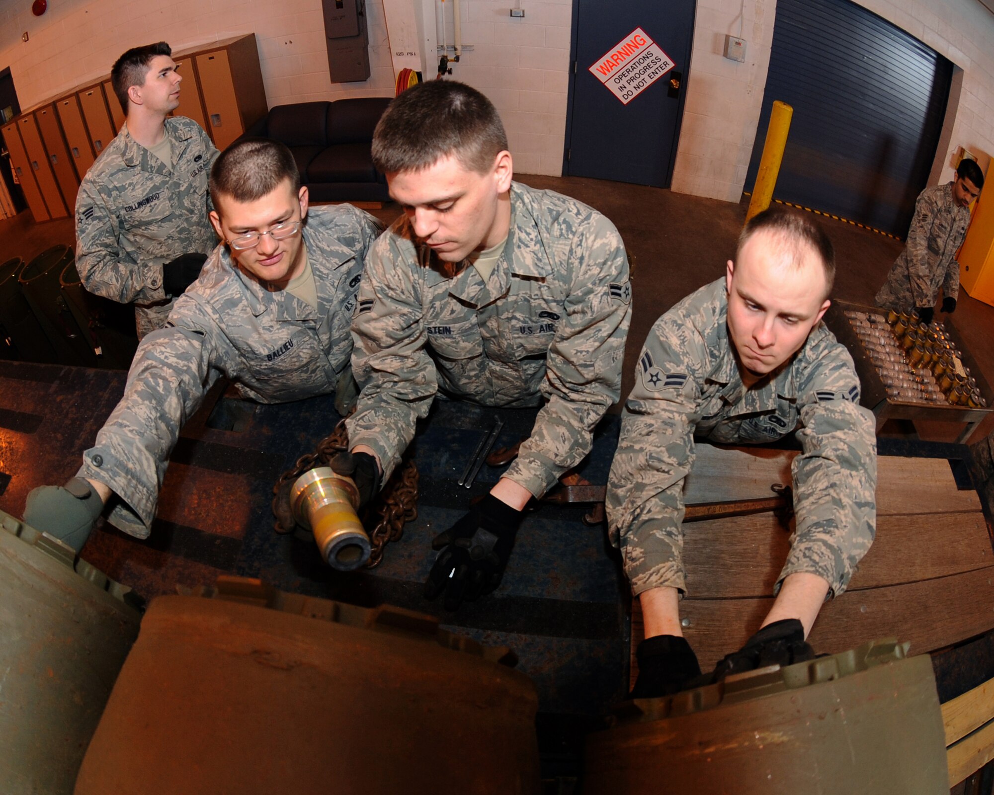MINOT AIR FORCE BASE, N.D. – 5th Munitions Squadron maintenance crew members, assemble M-117 unguided bombs by inserting the fuses in preparation for load barn training at the conventional maintenance shop on Minot Air Force Base March 9. Conventional maintenance crew members conduct familiarization and characteristic training with loading and assembling bombs to meet armor load standardizations in support for the 23rd and 69th Bomb Squadrons. (U.S. Air Force photo by Senior Airman Jesse Lopez)
