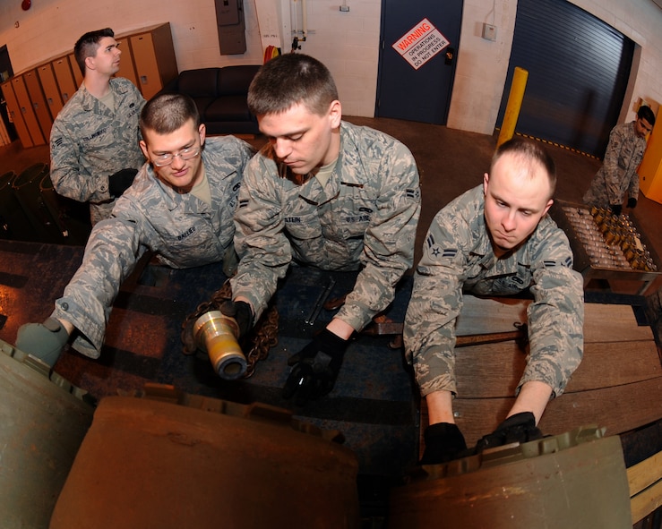 MINOT AIR FORCE BASE, N.D. – 5th Munitions Squadron maintenance crew members, assemble M-117 unguided bombs by inserting the fuses in preparation for load barn training at the conventional maintenance shop on Minot Air Force Base March 9. Conventional maintenance crew members conduct familiarization and characteristic training with loading and assembling bombs to meet armor load standardizations in support for the 23rd and 69th Bomb Squadrons. (U.S. Air Force photo by Senior Airman Jesse Lopez)