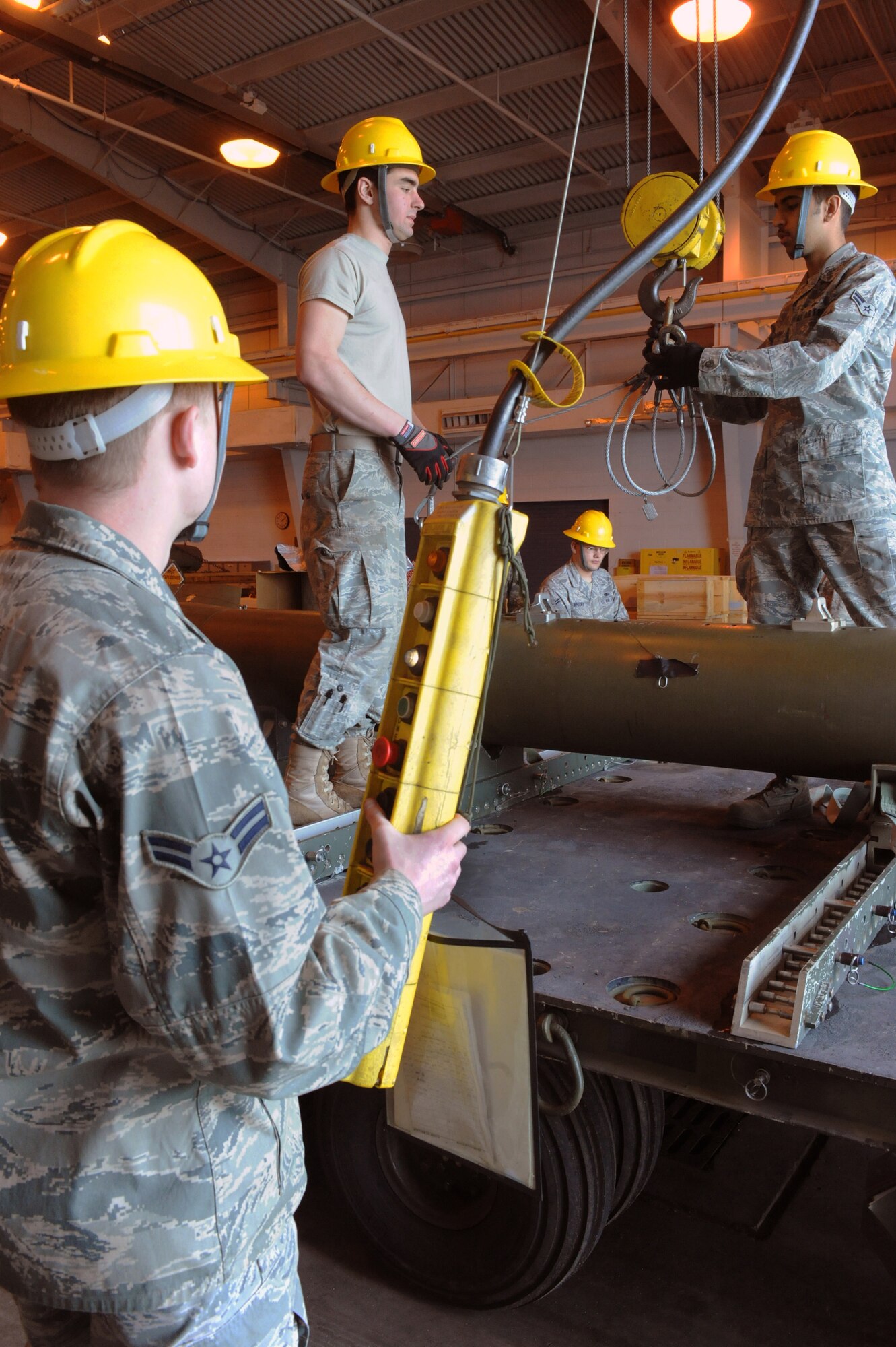 MINOT AIR FORCE BASE, N.D. – 5th Munitions Squadron maintenance crew members, load an inert laser guided bomb onto a munitions handling unit trailer at the conventional maintenance shop on Minot Air Force Base March 9. Conventional maintenance crew members conduct familiarization and characteristic training with loading and assembling bombs to meet armor load standardizations in support for the 23rd and 69th Bomb Squadrons. (U.S. Air Force photo by Senior Airman Jesse Lopez)