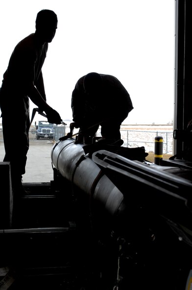 MINOT AIR FORCE BASE, N.D. -- 5th Munitions Squadron maintenance crew members load a GBU – 28 Paveway III inert laser-guided bomb at the conventional maintenance shop on Minot Air Force Base March 9. Conventional maintenance crew members conduct characteristic training by loading and assembling bombs to meet armor load standardizations to support the 23rd and 69th Bomb Squadrons. (U.S. Air Force photo by Airman 1st Class Aaron-Forrest Wainwright)