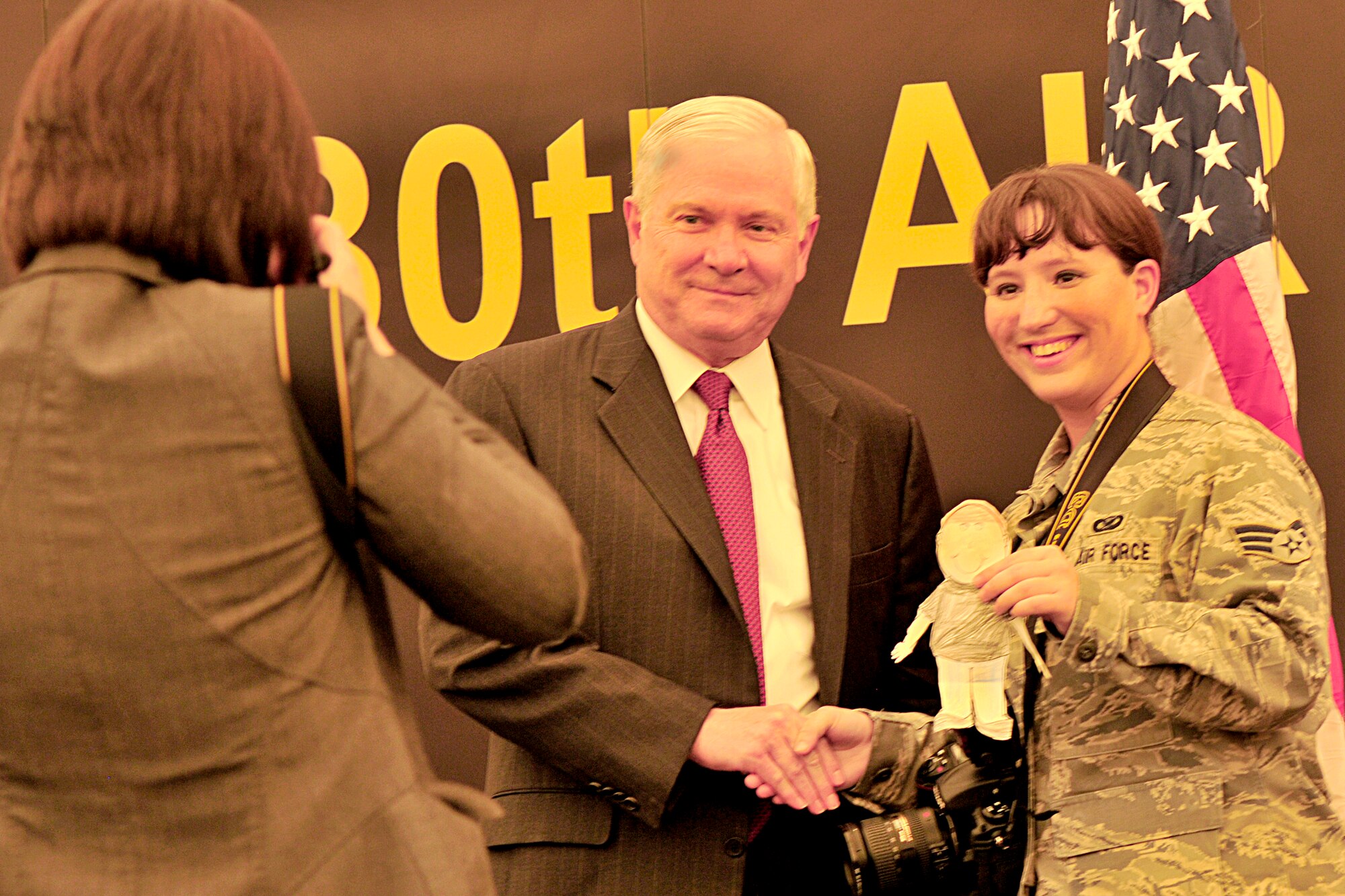 New York elementary school kids will be getting a surpise to find out a class project they started ended up in front of the U.S. Defense Secretary Robert M. Gates. During his visit to the 380th Air Expeditionary Wing at an undisclosed location in Southwest Asia on March 11, 2010, Senior Airman Jenifer Calhoun, wing photographer, poses with "Flat Joe" and Mr. Gates. She is helping facilitate the class project. (U.S. Air Force Photo/Capt. Cathleen Snow/Released) 