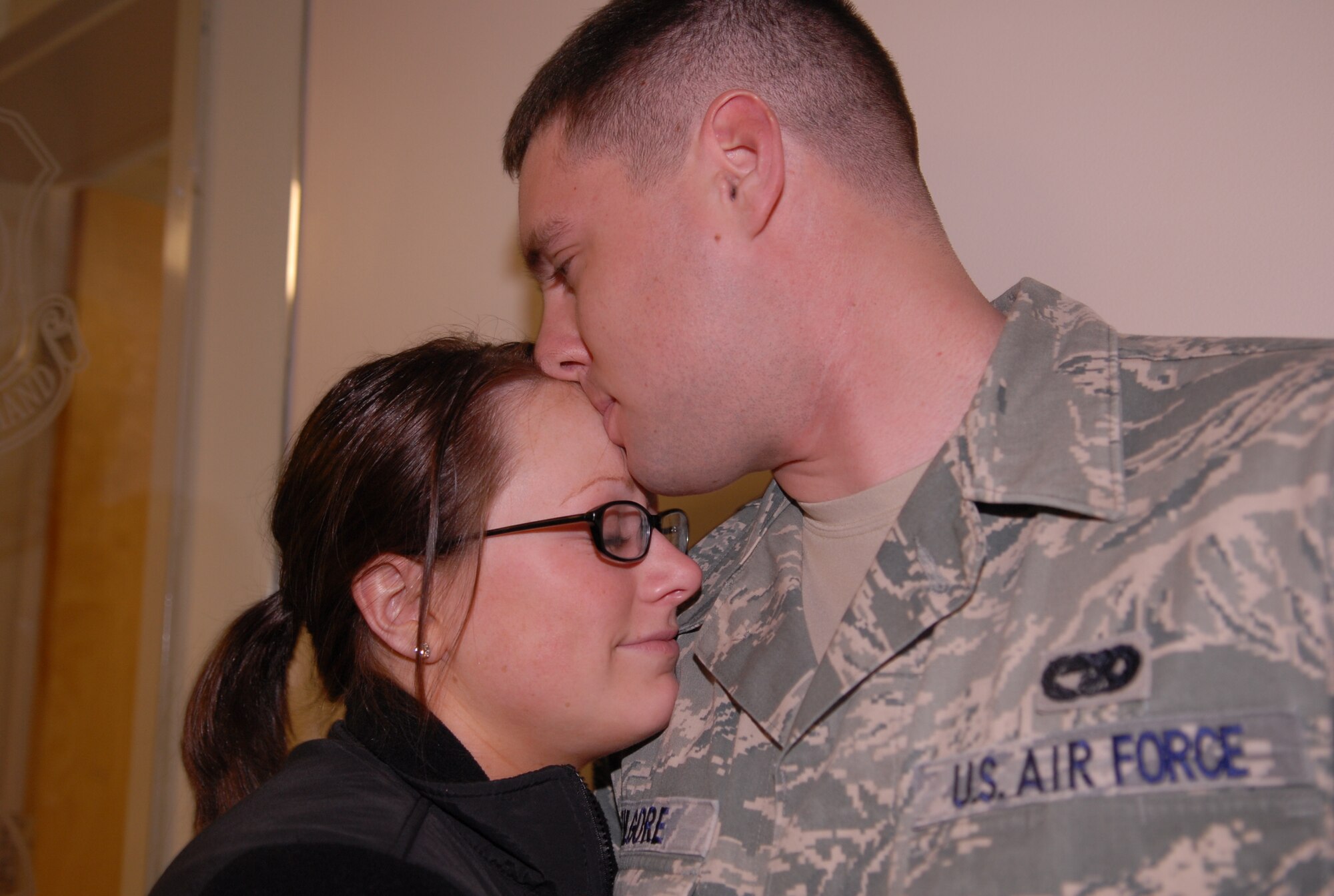 Airman 1st Class Cory Kilgore and Brittny Murphy say good-bye at a deployment ceremony here March 10. Fifteen members of 3rd APS left for a six-month deployment to Camp Bastion, Afghanistan. (U.S. Air Force photo by 2nd Lt. Cammie Quinn)