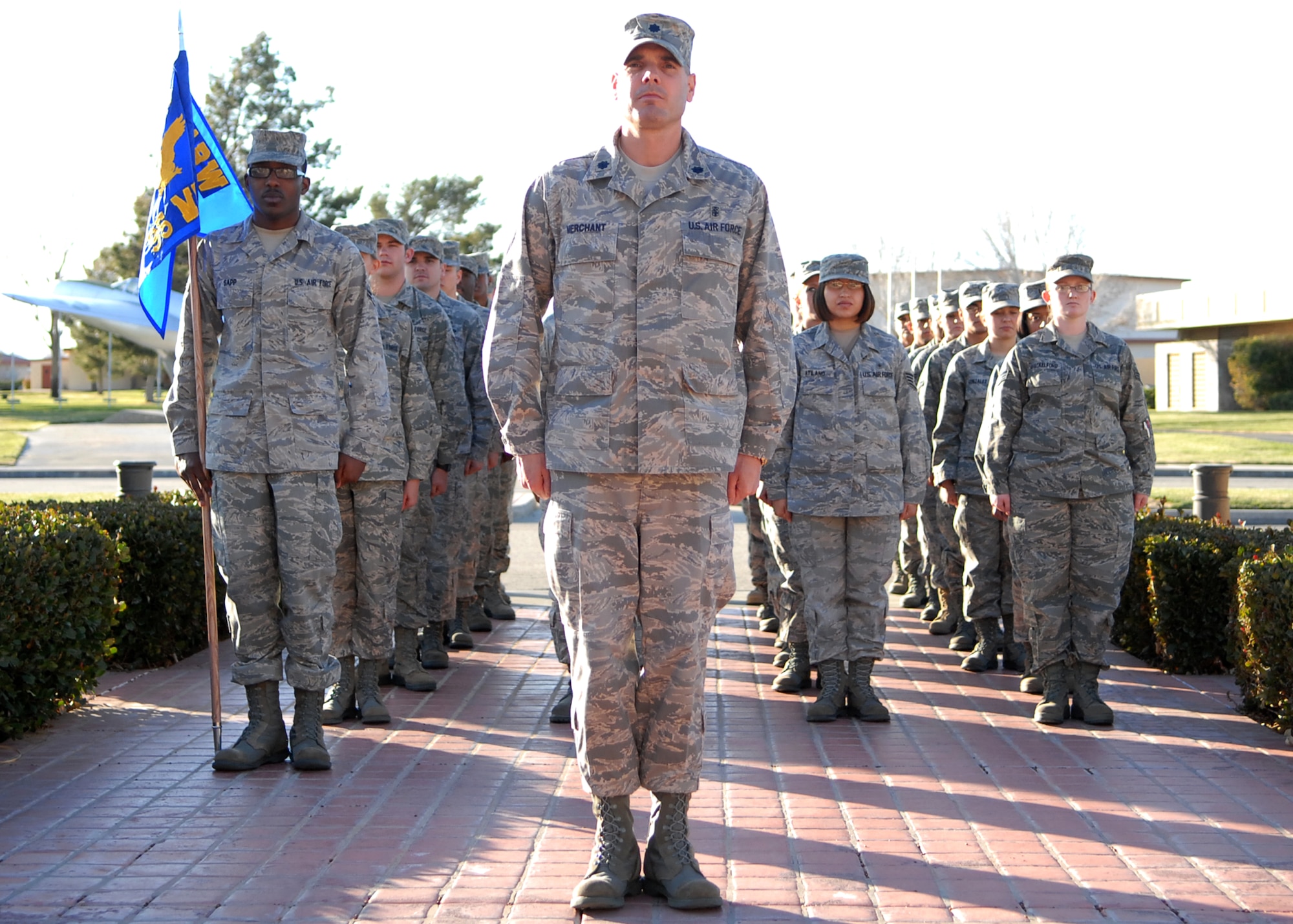 Lt. Col. Ronald Merchant, 95th Medical Support Squadron commander, leads a flight of Airmen during a retreat ceremony in front of the Air Force Flight Test Center Headquarters March 11. Team Edwards hosts a retreat ceremony monthly. Traditionally, a retreat ceremony marks the end of the duty day and honors the American Flag. (Air Force photo/Senior Airman William A. O'Brien)