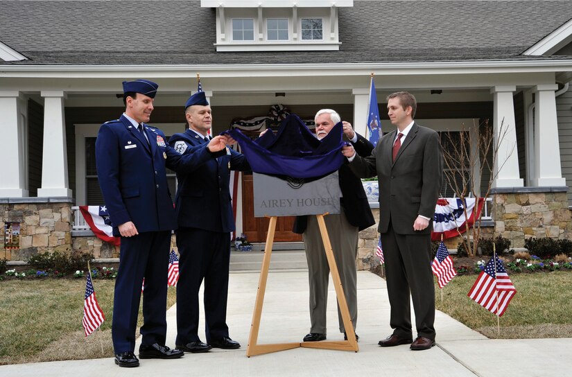 Colonel Steven Shepro, Joint Base Andrews/316th Wing commander, Chief Master Sgt. of the Air Force James A. Roy, retired Chief Master Sgt. Dale Airey, and Mike Dowling, Clark Realty representative unveil a plaque during a dedication ceremony at 1 Airey Court, Joint Base Andrews, Md., March 10, 2010.  The chief master sergeant of the Air Force’s new quarters, now “Airey House,” were dedicated to the first chief master sergeant of the Air Force, Paul W. Airey. Five former chief master sergeants of the Air Force and their spouses, members of Chief Airey’s family, Lt. Gen. William L. Shelton, assistant vice chief of staff, Headquarters U.S. Air Force, and members of Team Andrews attended. (U.S. Air Force photo/ Airman 1st Class Perry Aston)