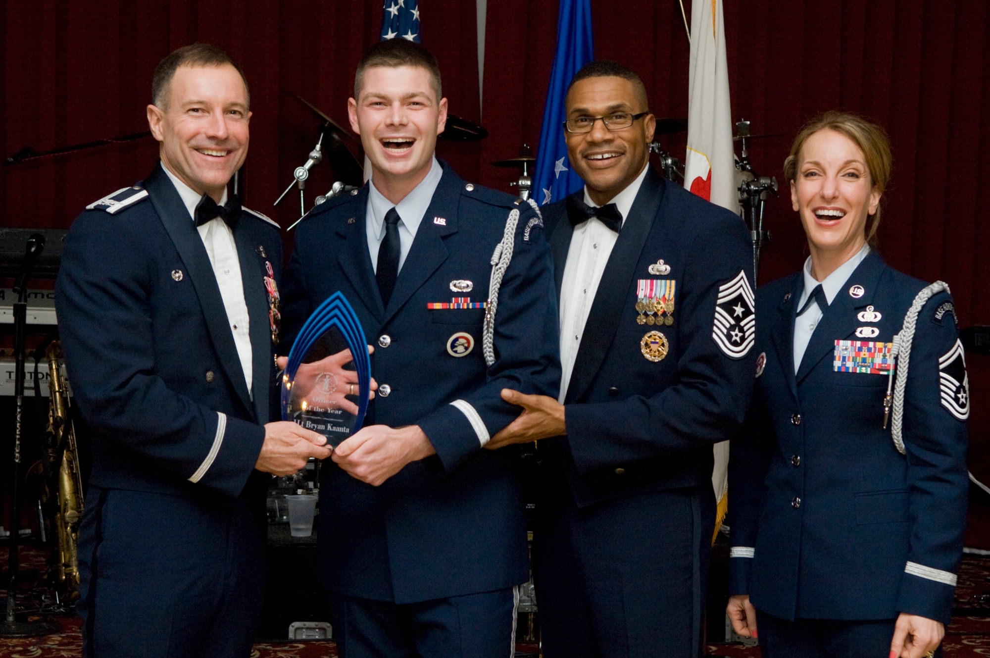 1st Lt. Bryan Kaanta (second from left), Air Force Research Laboratory, receives the Honor Guard Officer of the Year award from Col. Dave Orr (left), 66th Air Base Wing commander, Chief Master Sgt. Kenneth Williams, Electronic Systems Center and 66 ABW command chief master sergeant, and Senior Master Sgt. Laura Noel, Patriot Honor Guard superintendent, during the Honor Guard Appreciation Banquet, held Feb. 26 at the Minuteman Club.  (U.S. Air Force photo by Mark Wyatt) 