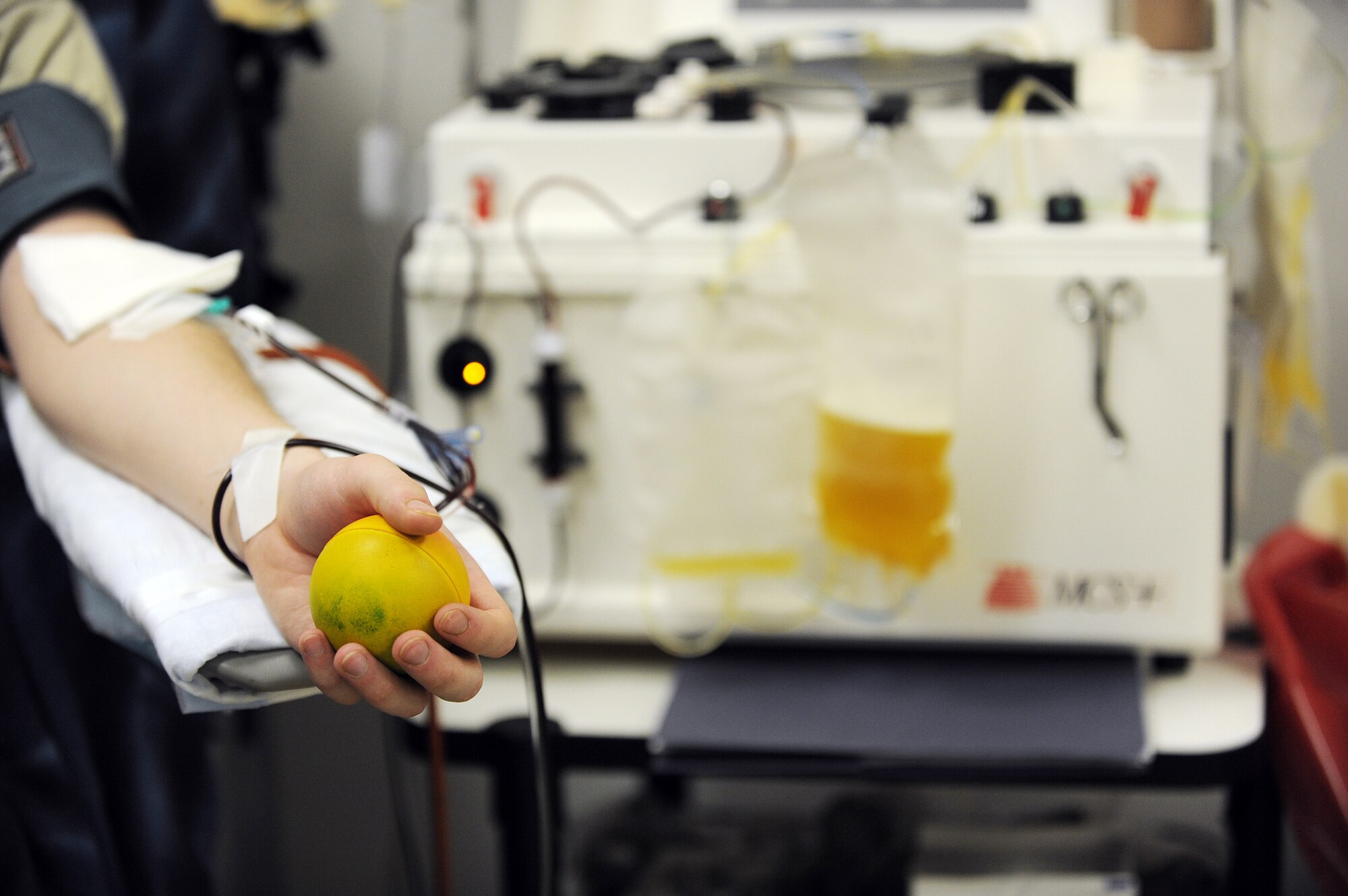 Staff Sgt. Ryan Eanes, a surveillance technician with the 727th Expeditionary Air Control Squadron at Joint Base Balad, Iraq, squeezes a stress ball during a platelet donation March 4, 2010. Sergeant Eanes has made nine donations during his deployment. The procedure takes approximately one and a half to two hours. Sergeant Eanes is deployed from Hill Air Force Base, Utah, and is a native of Denver, Colo. (U.S. Air Force photo/Master Sgt. Linda C. Miller)