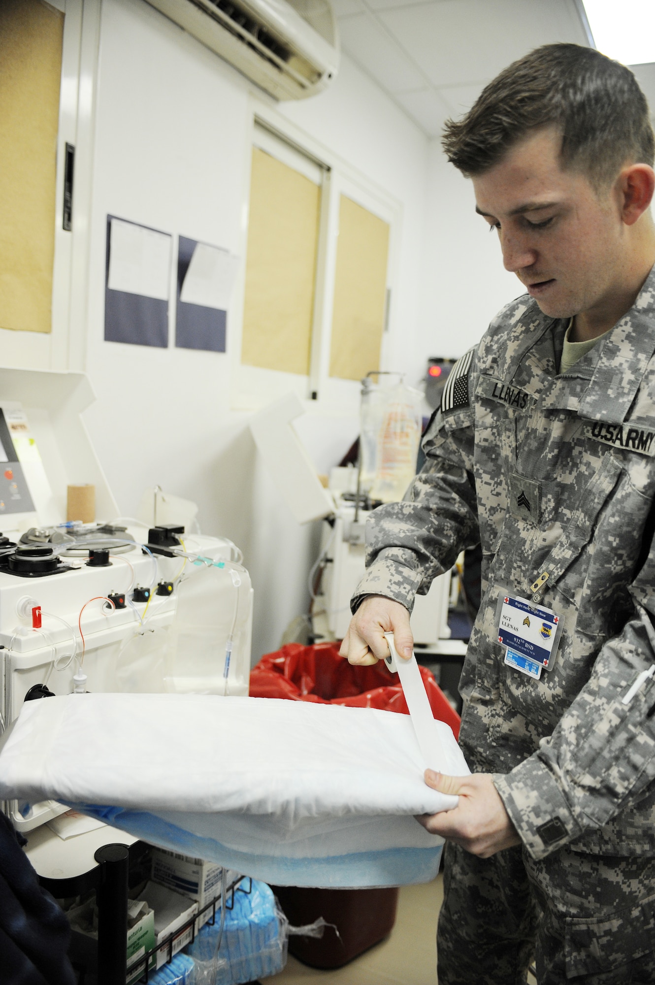 Army Sgt. Daniel Llenas, a lab technician with the 932nd Blood Support Detachment at Joint Base Balad, Iraq, prepares an arm resting table March 4, 2010, for a platelet donor. The technicians use an Apheresis machine that draws the blood, separates the platelets and then returns the blood to the donor. The procedure takes approximately one and a half to two hours.  Sergeant Llenas is deployed from Fort Hood, Texas, and is a native of Juneau, Alaska. (U.S. Air Force photo/Master Sgt. Linda C. Miller)