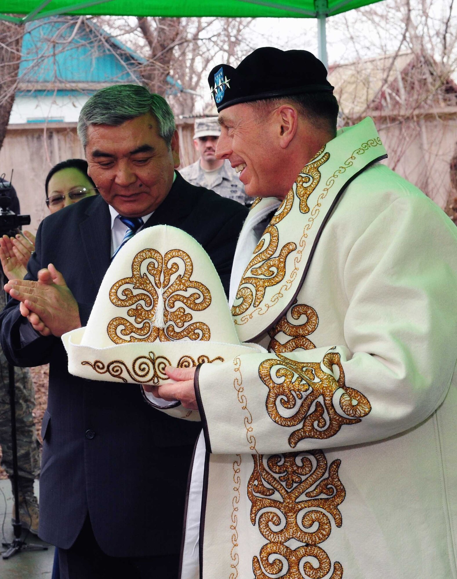 Army Gen. David Petraeus, Commander, U.S. Central Command, accepts a customized kalpak and robe during a groundbreaking ceremony at a building that will become the Women’s Center in Kyrgyzstan March 11, 2010. (U.S. Air Force photo/Staff Sgt. Carolyn Viss/released)