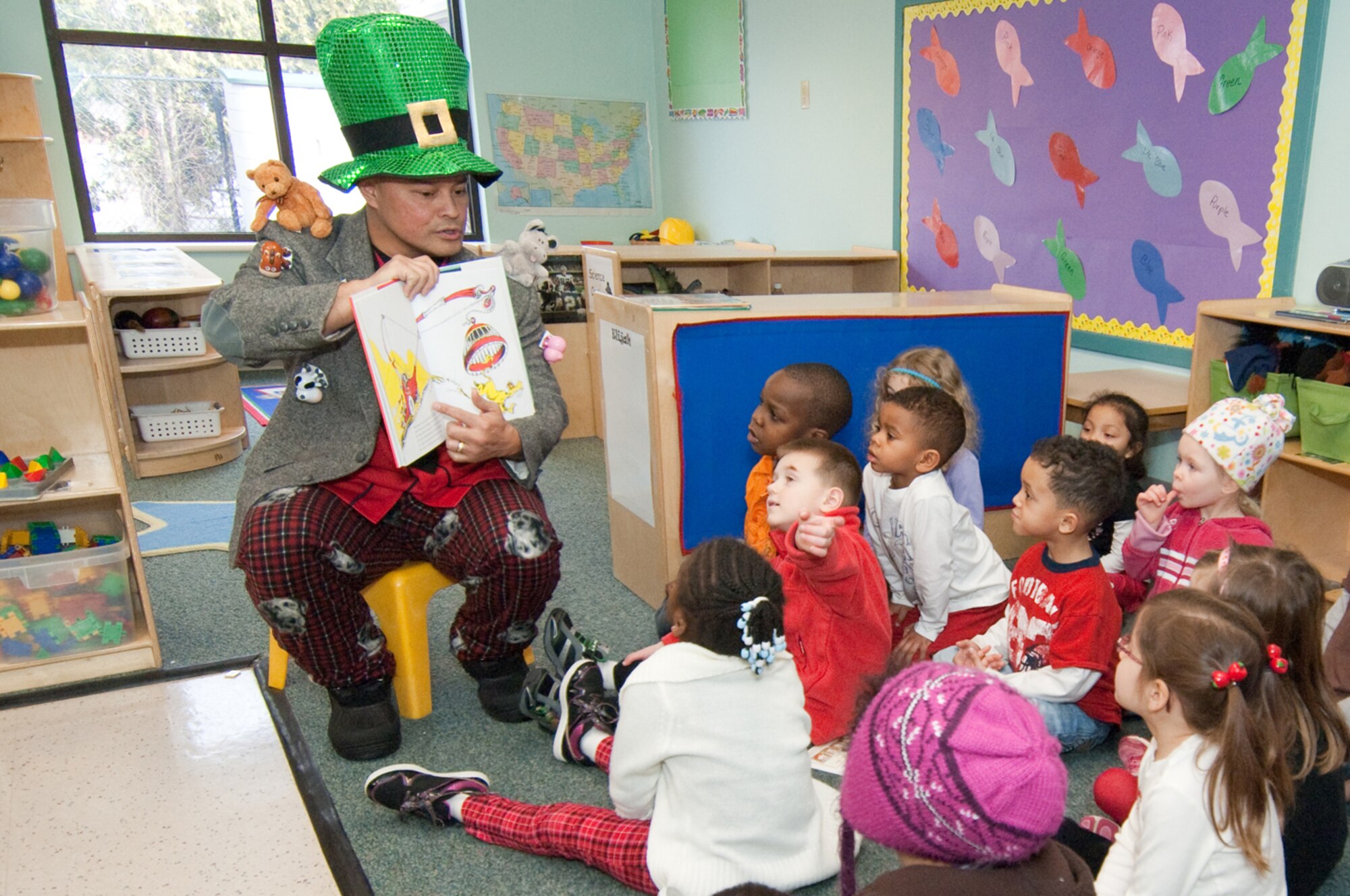 Chief Master Sgt. Glenn Taijeron, 66th Mission Support Group superintendent, entertains children at the Child Development Center on March 2, by reading a Dr. Seuss book as part of the National Education Association's Read Across America campaign.  (U.S. Air Force photo by Rick Berry)
