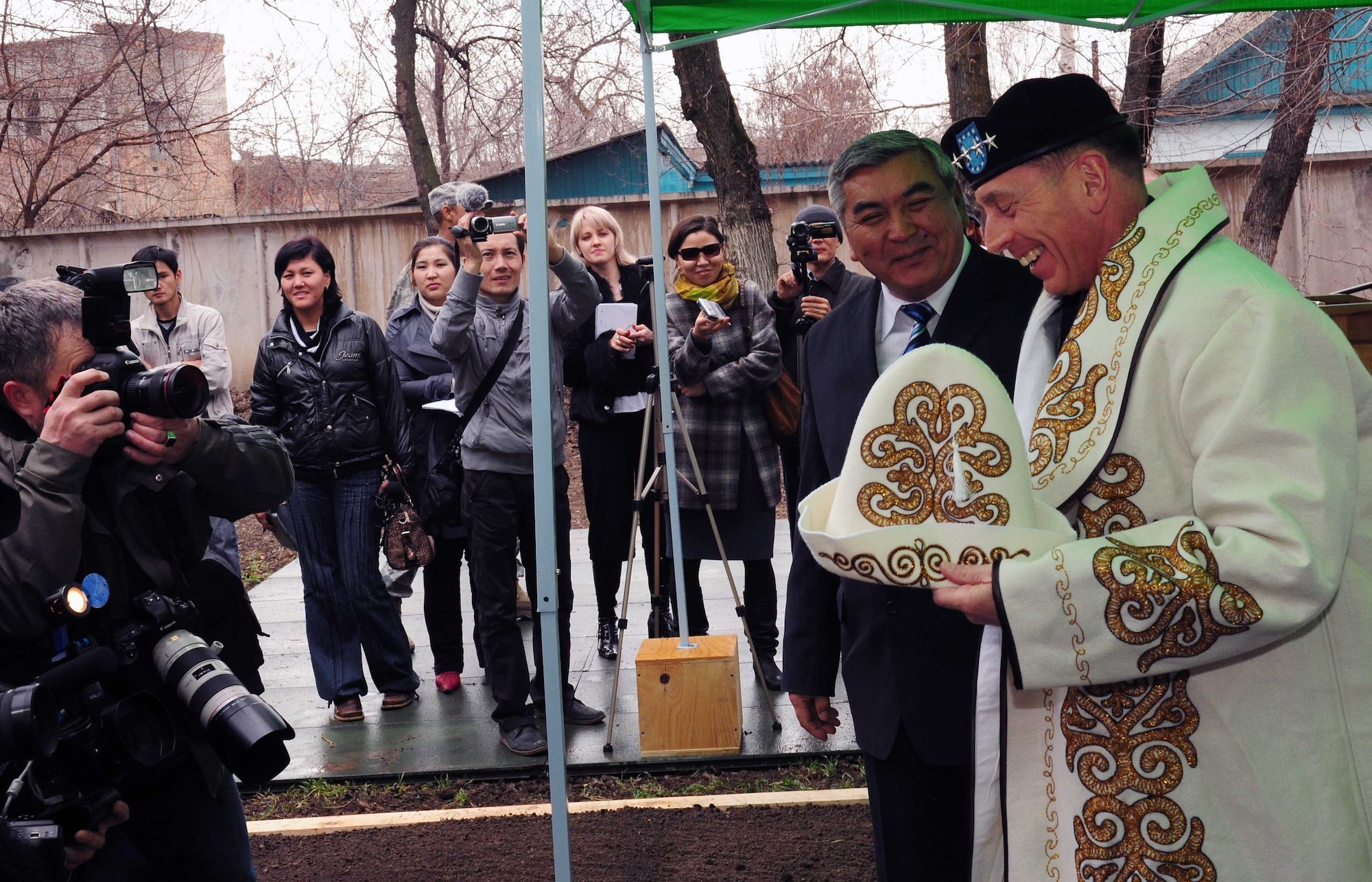 Army Gen. David Petraeus, Commander, U.S. Central Command, accepts a customized kalpak and robe during a groundbreaking ceremony at a building that will become the Women’s Center in Kyrgyzstan March 11, 2010. (U.S. Air Force photo/Staff Sgt. Carolyn Viss/released)