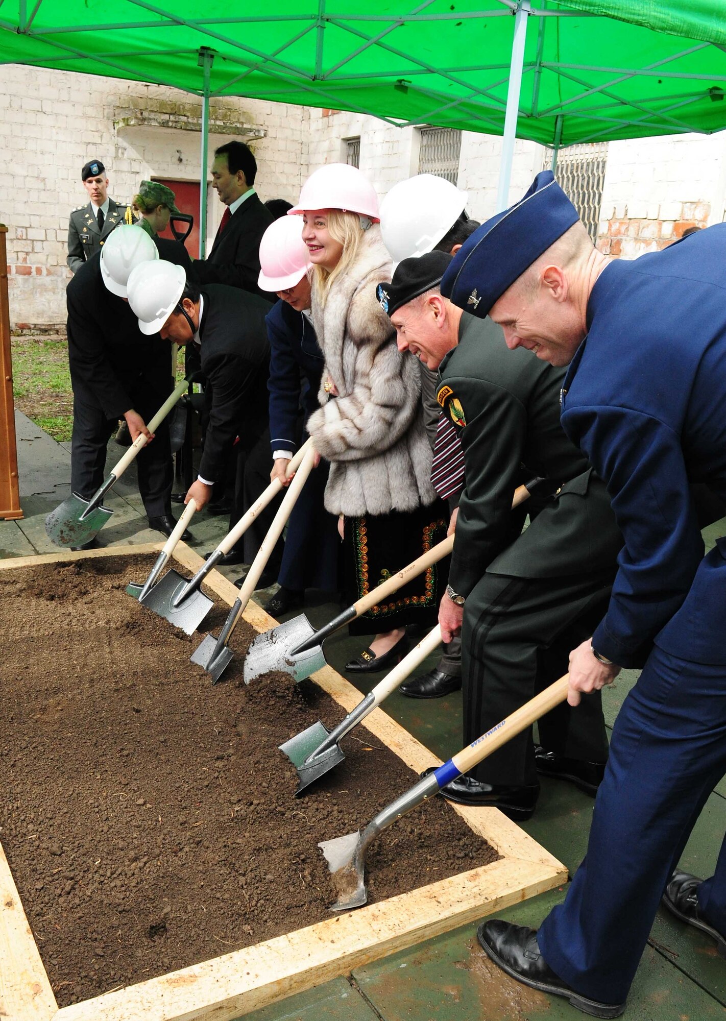 Army Gen. David Petraeus, Commander, U.S. Central Command, breaks ground with Transit Center at Manas director Air Force Col. Blaine Holt, U.S. Ambassador of Kyrgyzstan Tatiana Gfoeller, and other distinguished visitors during a ceremony at a building that will become the Women’s Center during the general’s trip to Kyrgyzstan, March 11, 2010. (U.S. Air Force photo/Staff Sgt. Carolyn Viss/released)