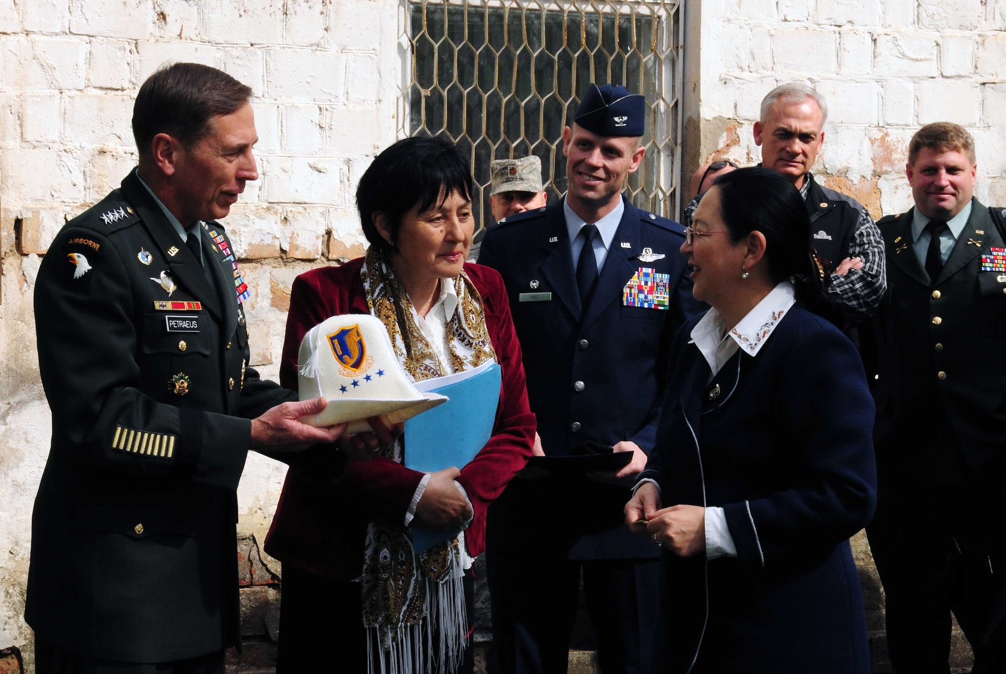 Army Gen. David Petraeus, Commander, U.S. Central Command, accepts a customized kalpak during a groundbreaking ceremony at a building that will become the Women’s Center during his trip to Kyrgyzstan, March 11, 2010. (U.S. Air Force photo/Staff Sgt. Carolyn Viss/released)
