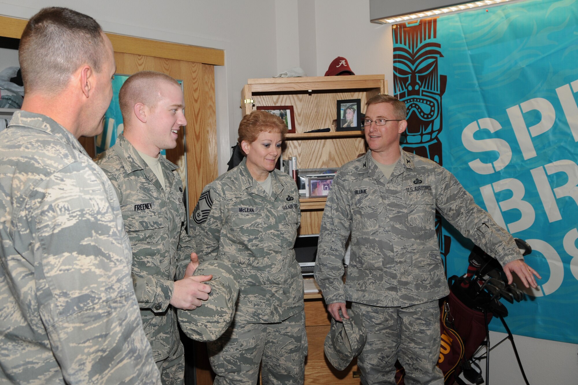Airman 1st Class Tyler Freeney, 90th Comptroller Squadron, shows his dormitory room to Air Force Global Strike Command Financial Managers  Col. Allen Blume and Chief Master Sgt. Jeannie McLean during their tour of Warren March 4. (U.S. Air Force photo/Berni Ernst)
