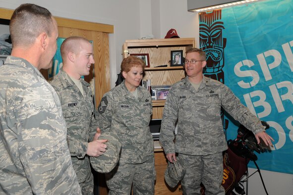 Airman 1st Class Tyler Freeney, 90th Comptroller Squadron, shows his dormitory room to Air Force Global Strike Command Financial Managers  Col. Allen Blume and Chief Master Sgt. Jeannie McLean during their tour of Warren March 4. (U.S. Air Force photo/Berni Ernst)