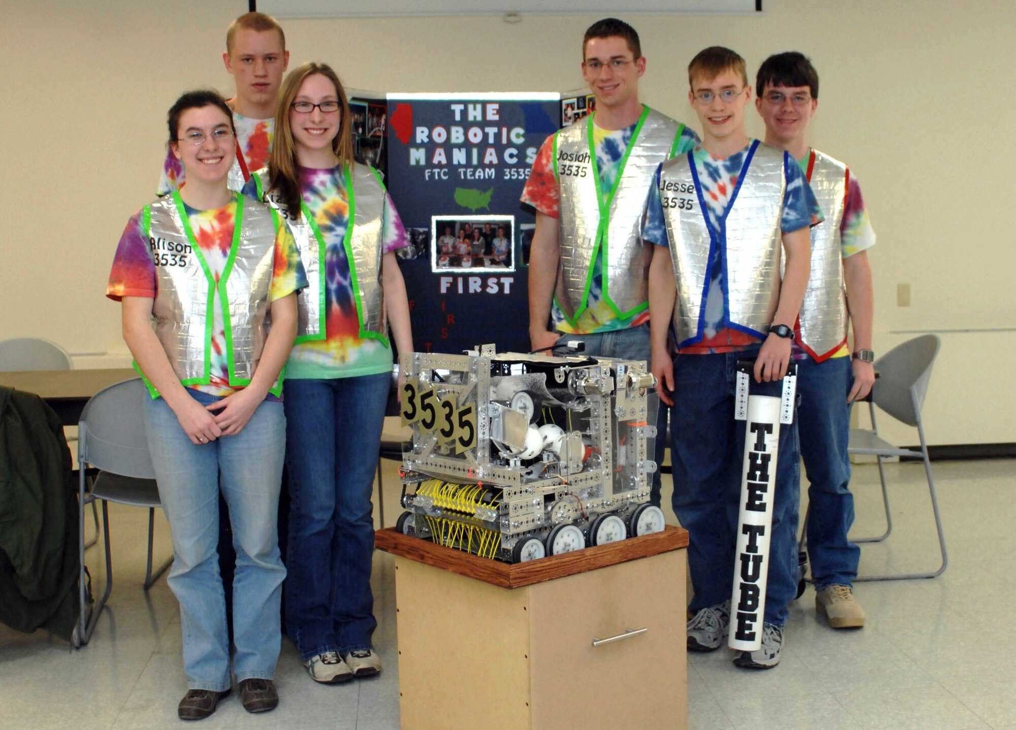 The Robotic Maniacs, a six-person team consisting of homeschooled high school students, four of whom are military dependents from Scott Air Force Base, Ill., pose with Zippy the robot March 3, 2010, at Scott AFB. The team will be traveling to Atlanta in mid-April to compete against 100 teams from all over the world during the FIRST, For Inspiration and Recognition of Science and Technology, World Festival. FIRST is a world-wide organization that promotes an interest in engineering and technology among school-age students. (U.S. Air Force photo/Senior Airman Samantha S. Crane)