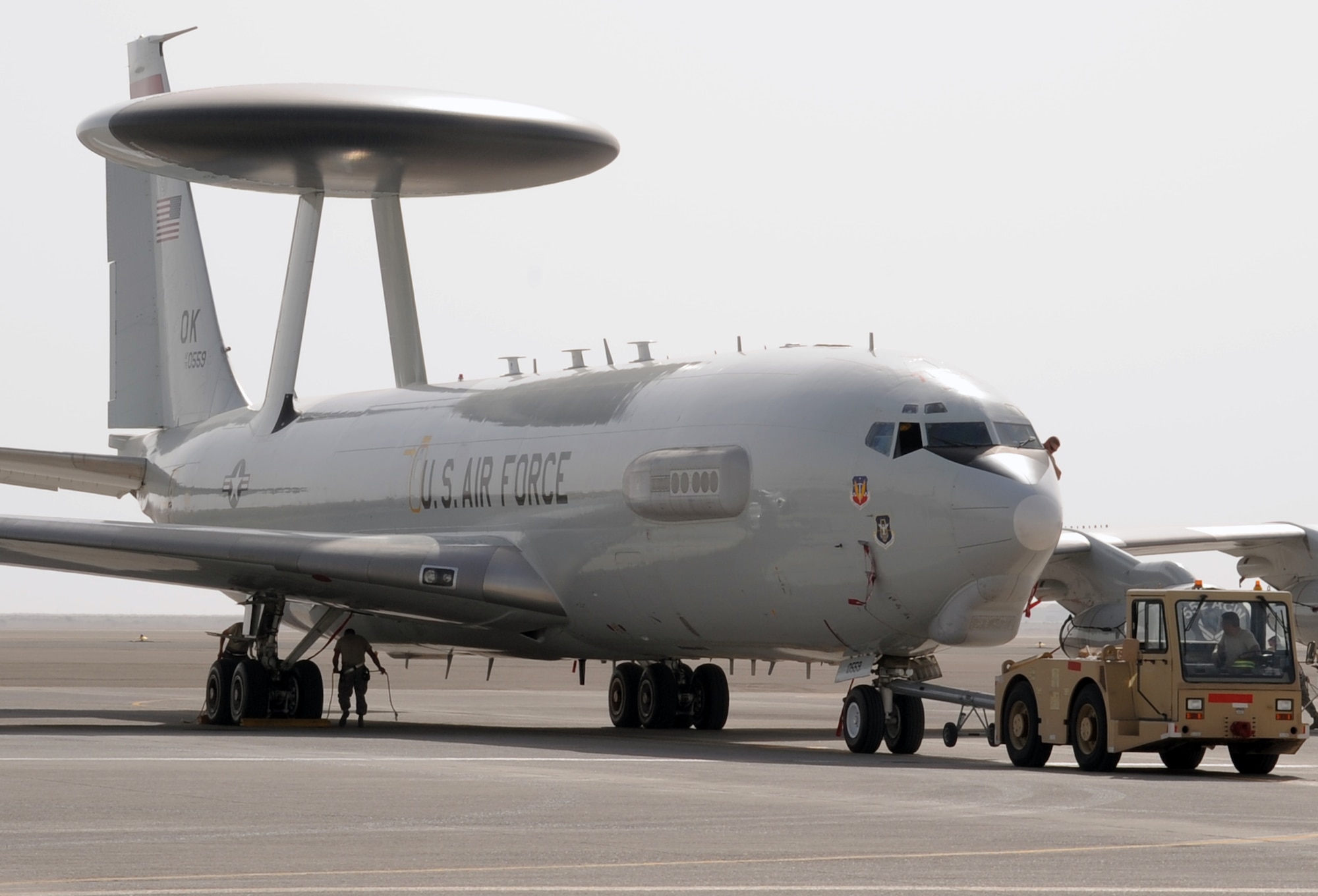 Maintenance Airmen from the 380th Expeditionary Aircraft Maintenance Squadron's Sentry aircraft maintenance unit use a "tug" to move an E-3 Sentry Airborne Warning and Control System aircraft during flightline operations at a non-disclosed base in Southwest Asia on March 8, 2010. The 380th EAMXS, as part of the 380th Air Expeditionary Wing, supports operations Iraqi Freedom and Enduring Freedom and the Combined Joint Task Force-Horn of Africa.  The E-3 Sentrys and their associated maintenance Airmen are deployed from Tinker Air Force Base, Okla. (U.S. Air Force Photo/Master Sgt. Scott T. Sturkol/Released)