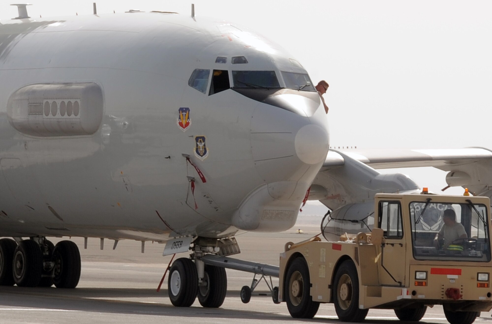 Maintenance Airmen from the 380th Expeditionary Aircraft Maintenance Squadron's Sentry aircraft maintenance unit use a "tug" to move an E-3 Sentry Airborne Warning and Control System aircraft during flightline operations at a non-disclosed base in Southwest Asia on March 8, 2010. The 380th EAMXS, as part of the 380th Air Expeditionary Wing, supports operations Iraqi Freedom and Enduring Freedom and the Combined Joint Task Force-Horn of Africa.  The E-3 Sentrys and their associated maintenance Airmen are deployed from Tinker Air Force Base, Okla. (U.S. Air Force Photo/Master Sgt. Scott T. Sturkol/Released)