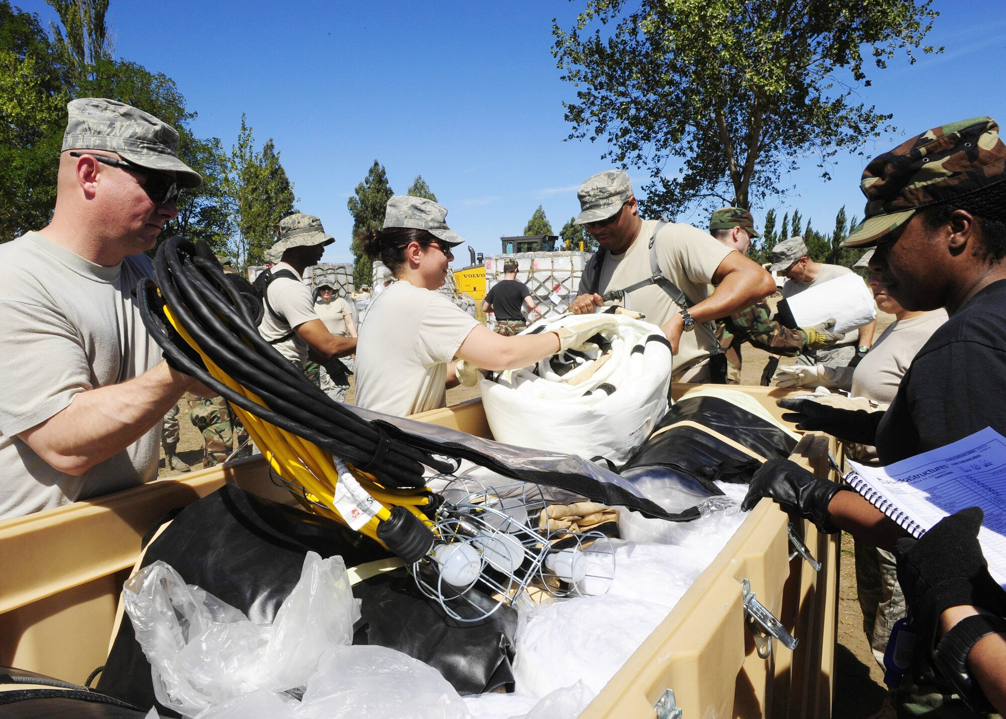 Airmen from an Air Force Expeditionary Medical Support team unload supplies for mobile hospital March 10, 2010, in Angol, Chile. The EMEDS staff and members of the Chilean army built the hospital to help augment medical services for nearly 110,000 Chileans in the region. The EMEDS team is equipped and staffed to provide surgical, primary care, pediatric, radiological, gynecological, laboratory, pharmaceutical and dental services. (U.S. Air Force photo/Senior Airman Tiffany Trojca)