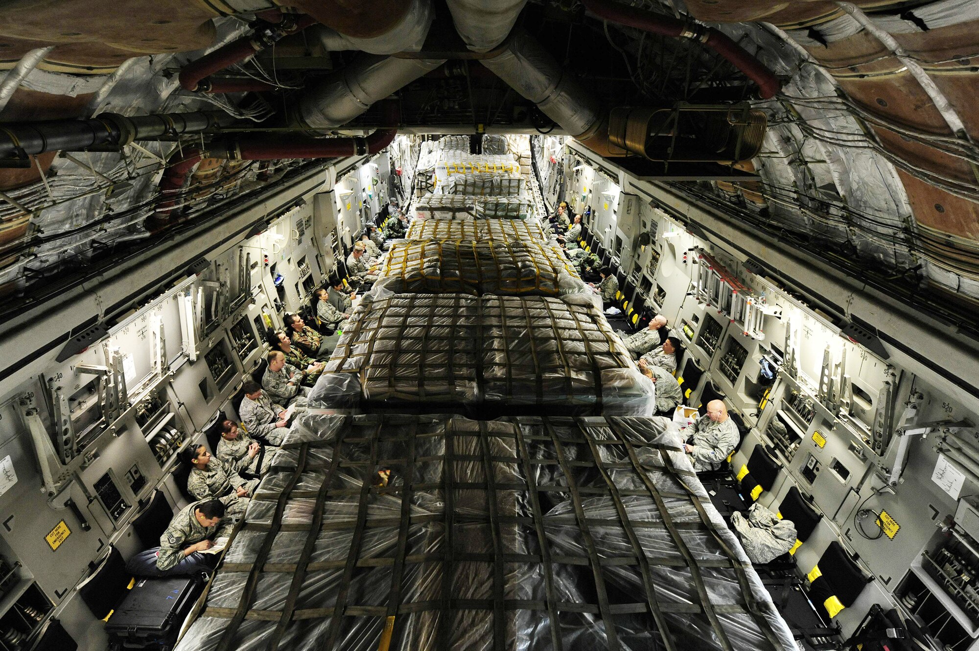 Airmen sit on a C-17 Globemaster III awaiting departure March 8, 2010, from Lackland Air Force Base, Texas. The Airmen are part of an Air Force Expeditionary Medical Support team that deployed to Angol, Chile, to augment medical care for more than 110,000 Chileans in the region. (U.S. Air Force photo/Senior Airman Tiffany Trojca)