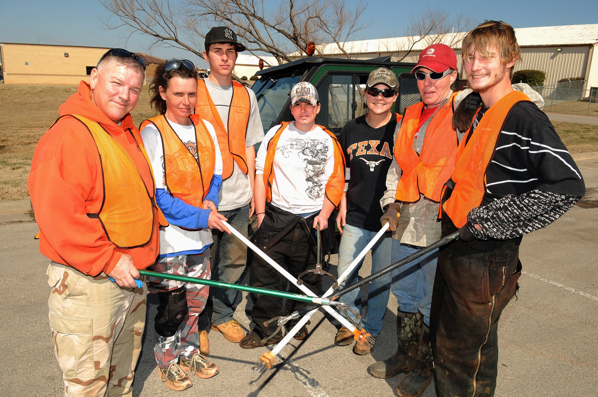 The 72nd Air Base Wing Civil Engineer team responsible for picking up Tinker’s trash has their hands full on a daily basis. From left: David Bigham, Casaundra “Candy” George, Chris Hansen, Carol Dawn Enloe, Jessica “Mush” Smith, Jennifer Williams and Thomas (TJ) Baden all take turns driving the “mule” around and keeping the base clean. The team picks up trash in every area of the base except housing and the golf course. When the ground is dry, they even go “off road” and pick up trash blown against Tinker’s exterior fence lines. The wind is a huge enemy in the war against trash. The team said they pick up six to 10 55-gallon bags every day. “It piles up pretty quick,” said assistant project manager Matt Davis. (Air Force photo by Dave Faytinger)
