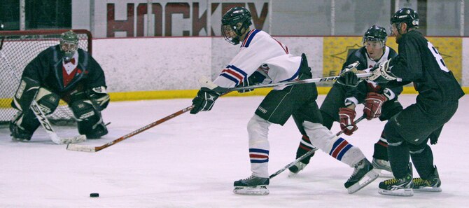 Nordiques forward Bryson Harley speeds through two Party Boys defenders March 7 on his drive toward the goal. Harley scored a goal in Sunday’s game but the Party Boys bested Tinker 8-5 in the end. (Air Force photo by John Stuart)
