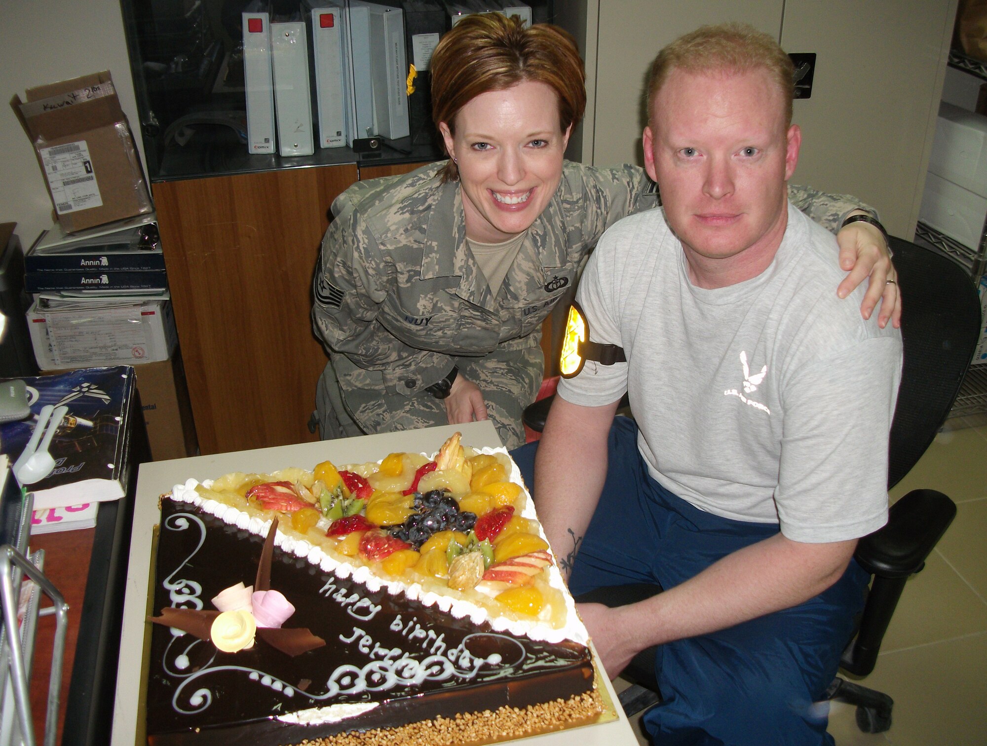 Tech. Sgt. Jennifer Nuy, 386th Expeditionary Operations Group weather flight chief, and her big brother, Staff Sgt. Jeremy Pickens, 817th Expeditionary Airlift Squadron C-17 loadmaster, celebrate their birthdays together Feb.  25, 2010 at an air base in Southwest Asia. The siblings, both Union Town, Ohio, natives, were together on their birthdays for the first time in 16 years. Sergeant Nuy is assigned to the 43rd Operations Support Squadron at Pope Air Force Base, N.C. and Sergeant Pickens is assigned to the 21st Airlift Squadron at Travis AFB, Calif. (U.S. Air Force photo/Released) 