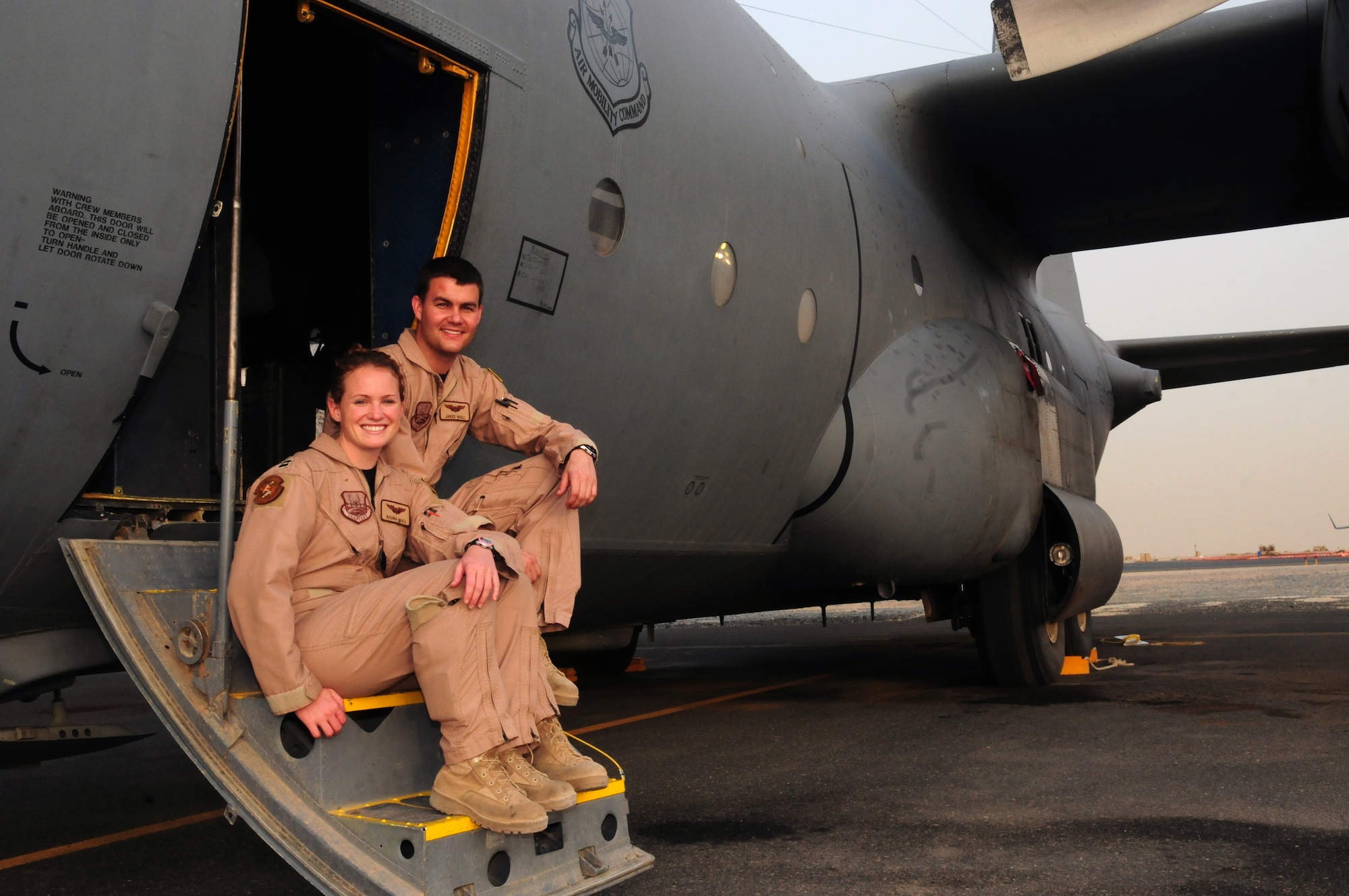 U.S. Air Force Capts. Regina and Jared Wall, C-130 pilots with the 39th Airlift Squadron at Dyess Air Force Base, Texas, are serving on their second deployment together with the 737th Expeditionary Airlift Squadron at an air base in Southwest Asia. (U.S. Air Force photo by Staff Sgt. Lakisha A. Croley/Released)