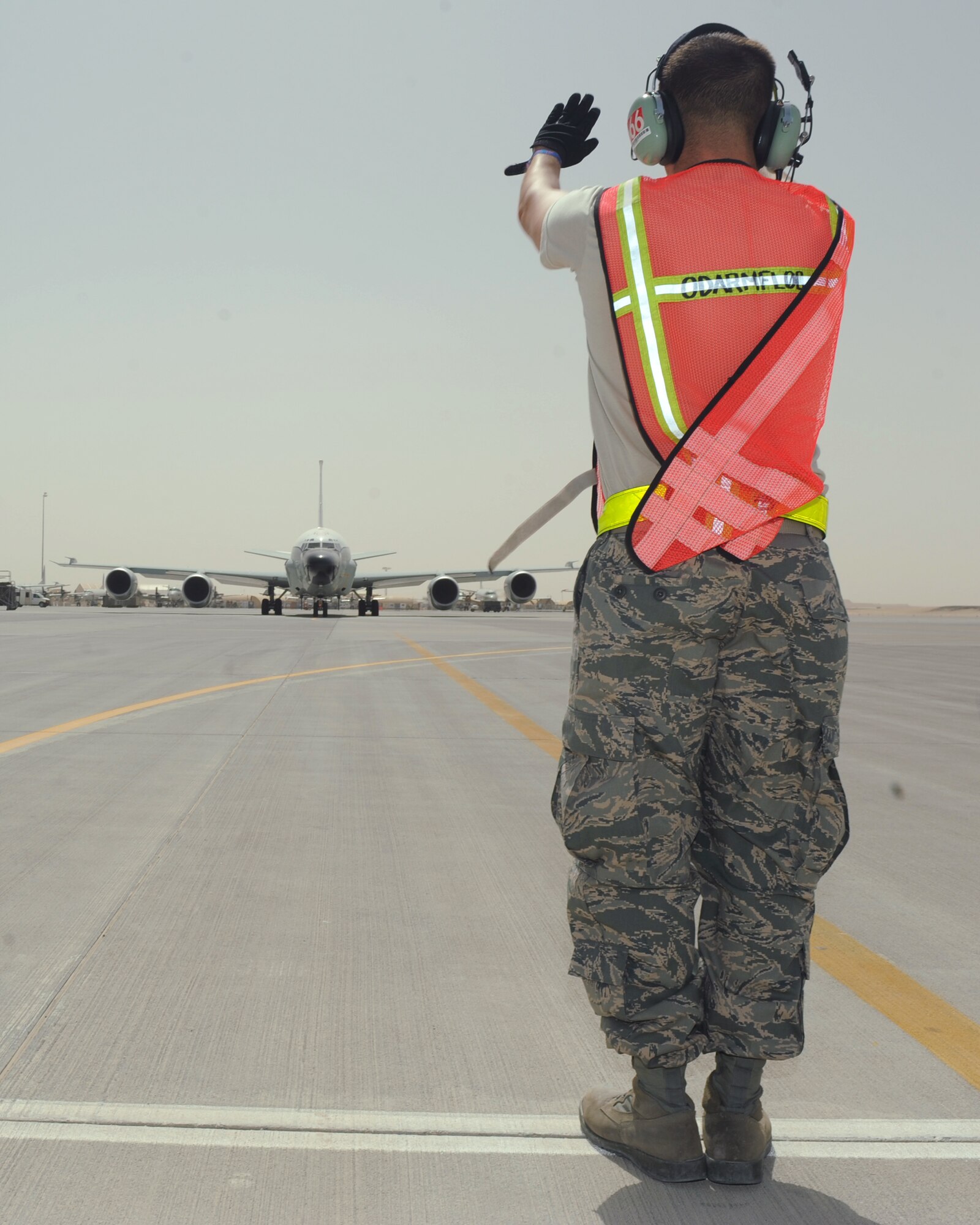 Senior Airman Jonathan Robertson, 55th Aircraft Maintenance Unit RC-135 crew chief, marshalls an RC-135 aircraft for takeoff at a non-disclosed Southwest Asia location, Mar 8, 2010. (U.S. Air Force photo by Tech. Sgt. Michelle Larche)[RELEASED]