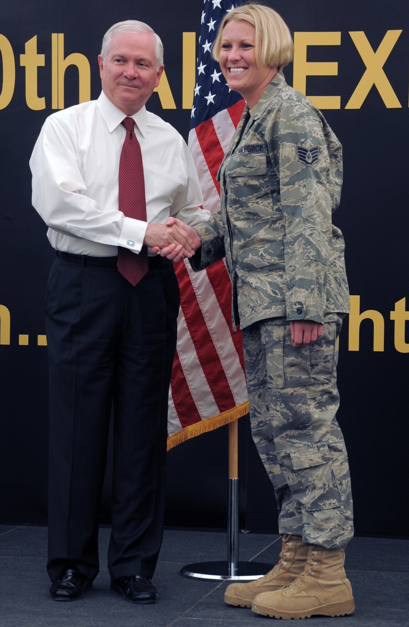 U.S. Defense Secretary Robert M. Gates presents a coin to Staff Sgt. Nicole Pollard, 380th Expeditionary Medical Group, during the secretary's visit to see the men and women of the 380th Air Expeditionary Wing at an non-disclosed location in Southwest Asia on March 11, 2010. During the town hall meeting, Secretary Gates gave some brief comments, answered questions from the deployed service members, and presented each in attendance with a coin.  The stop at the 380th AEW was part of Secretary Gates' trip through several countries meeting with U.S. allies.  (U.S. Air Force Photo/Master Sgt. Scott T. Sturkol/Released)