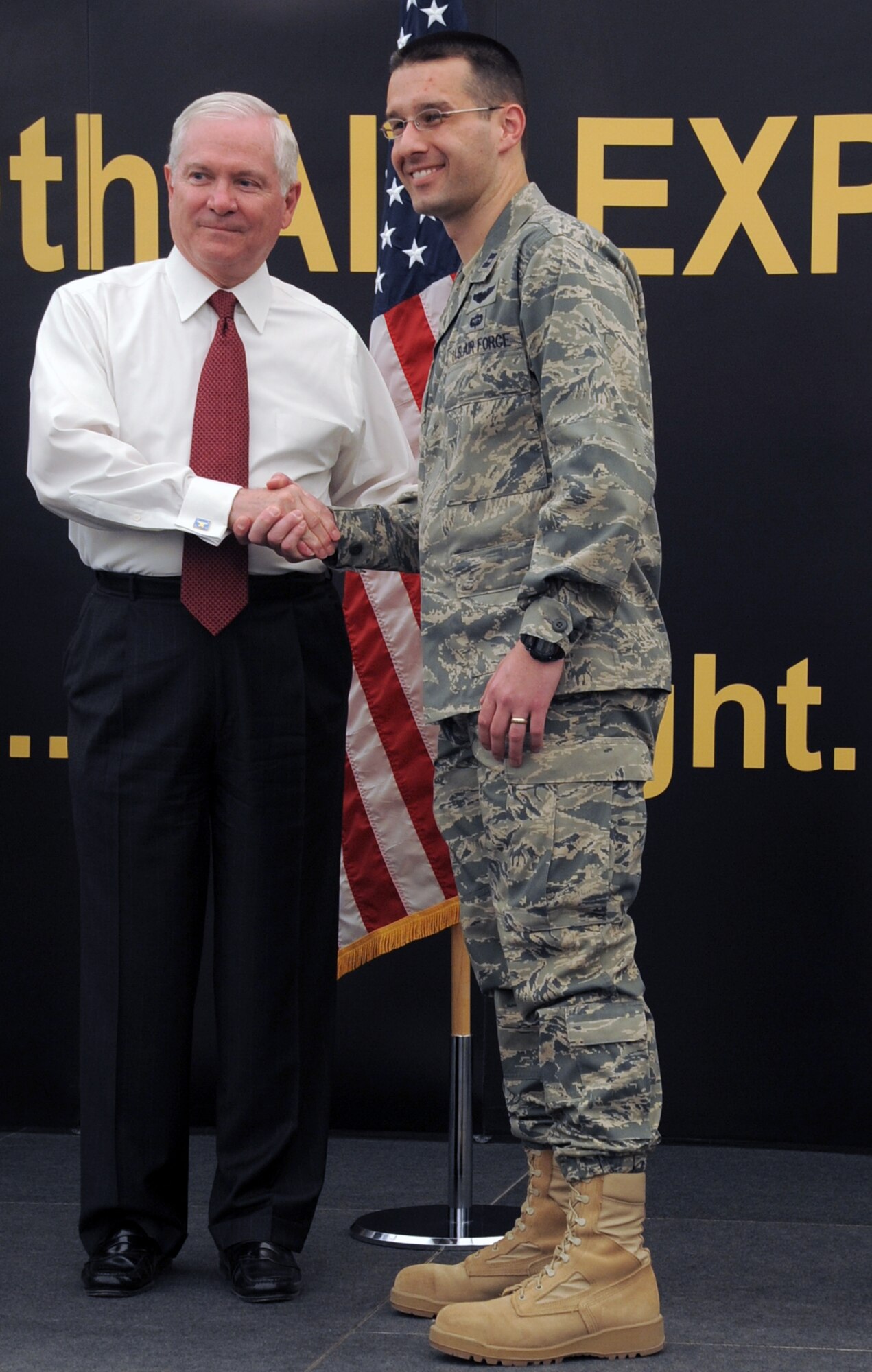 U.S. Defense Secretary Robert M. Gates presents a coin toCapt. Jeff Cameron, executive officer to the commander of the 380th Air Expeditionary Wing during the secretary's visit to see the men and women of the 380th AEW at an non-disclosed location in Southwest Asia on March 11, 2010. During the town hall meeting, Secretary Gates gave some brief comments, answered questions from the deployed service members, and presented each in attendance with a coin.  The stop at the 380th AEW was part of Secretary Gates' trip through several countries meeting with U.S. allies.  (U.S. Air Force Photo/Master Sgt. Scott T. Sturkol/Released)