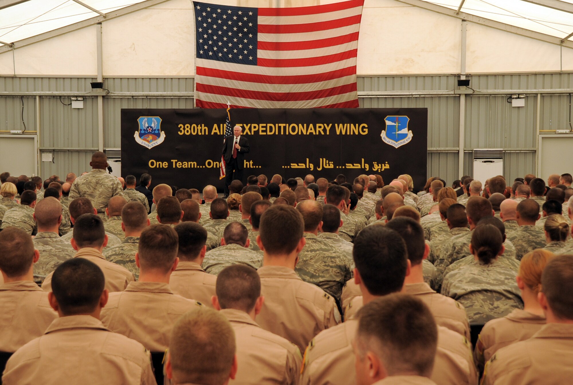 U.S. Defense Secretary Robert M. Gates addresses the men and women of the 380th Air Expeditionary Wing at an non-disclosed location in Southwest Asia on March 11, 2010. During the town hall meeting, Secretary Gates gave some brief comments, answered questions from the deployed service members, and presented each in attendance with a coin.  The stop at the 380th AEW was part of Secretary Gates' trip through several countries meeting with U.S. allies.  (U.S. Air Force Photo/Master Sgt. Scott T. Sturkol/Released)