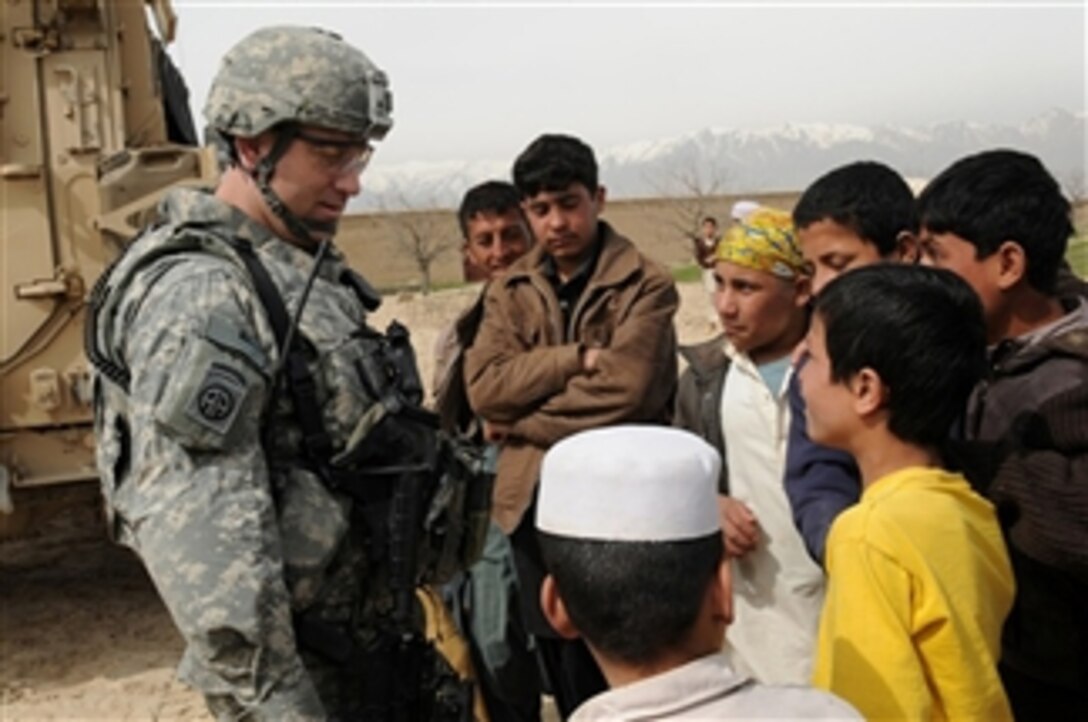 U.S. Army 1st Sgt. James Herrington, the Parwan Provincial Reconstruction Team first sergeant, talks to children of the Qal eh-ye Nasro village after a key leader engagement with a village elder in the Parwan province of Afghanistan on March 9, 2010.  Topics of discussion include the possibility of improving the roads, getting more wells for the village and various agricultural and economic issues faced by the people of Qal eh-ye Nasro.  