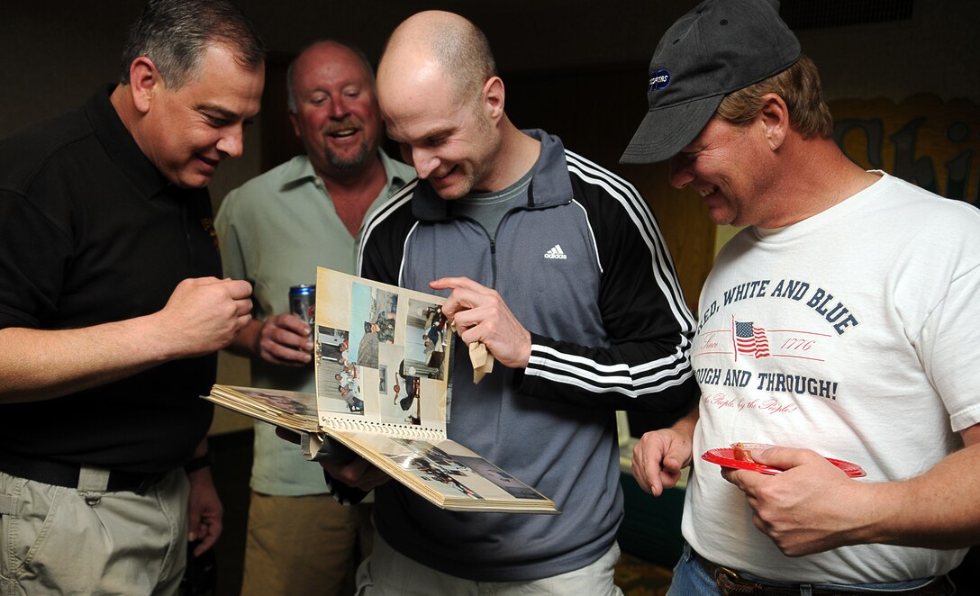 Michael Danko, left, John Gloshen, Gus Tomerelli and Mike Traficano, former station military policemen from the mid ’80s, reminisce as they look through photos from their time spent in Yuma during their 25-year reunion March 12. The group of nine friends returned to Yuma March 12 to visit their roots, renew old friendships and witness the growth of the city and the air station. “It’s great to get together with these guys I worked with 25 years ago and share stories and experiences about the base,” said Traficano, who served as a station MP 1986-87. “I hope we have another one of these in the future. It’s all about the camaraderie.”