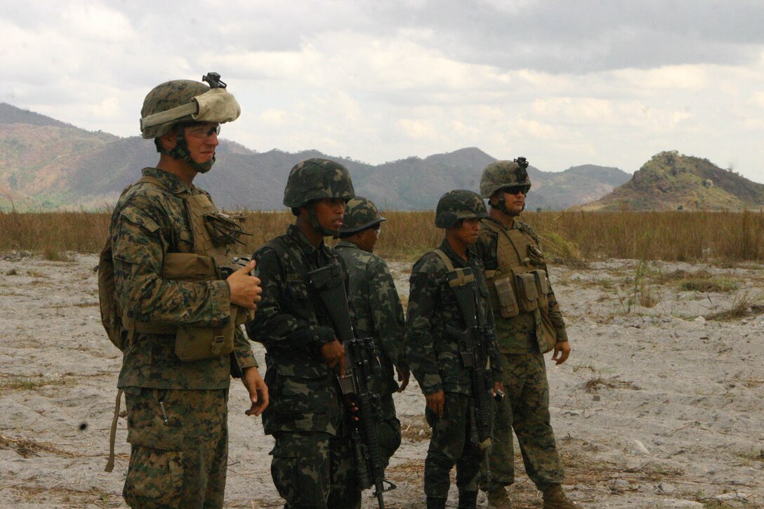 Republic of the Philippines Marines and U.S. Marines with Battalion Landing Team 2nd Battalion, 7th Marines (BLT 2/7), 31st Marine Expeditionary Unit (MEU), observe their targets 100 meters down range during a small-arms shoot, March 13.  The small-arms shoot was part of bilateral training being conducted during exercise Balikatan 2010 (BK ’10). (Official Marine Corps photo by Cpl. Michael A. Bianco)