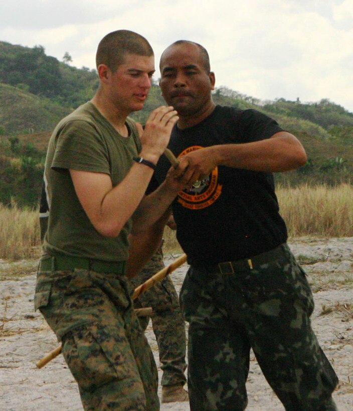 Lance Cpl. Taylor Jasper, a rifleman with Company E, Battalion Landing Team 2nd Battalion, 7th Marines (BLT 2/7), 31st Marine Expeditionary Unit (MEU), practices Pekithtirsia defense move with a Philippine martial arts instructor, March 13.  The martial arts class was part of bilateral training being conducted during exercise Balikatan 2010 (BK ’10). (Official Marine Corps photo by Cpl. Michael A. Bianco)