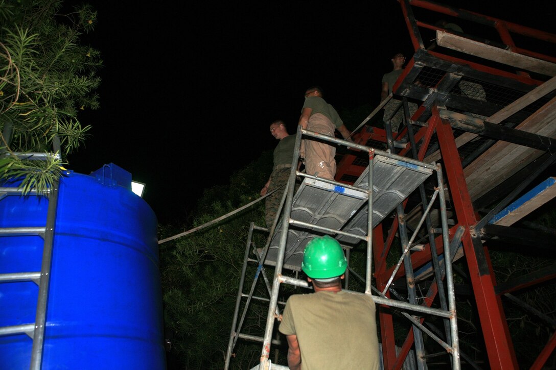 Marines with Combat Logistics Battalion 31 (CLB-31), 31st Marine Expeditionary Unit (MEU), prepare to load a new water tank on a metal tower frame during an engineering civil affairs project (ENCAP) at Marnay Primary School, March 13. CLB-31 along with the Armed Forces of the Philippines (AFP) are renovating the school to support the local Filipino community in support of exercise Balikatan 2010 (BK ’10). (Official Marine Corps photo by Lance Cpl. Dengrier M. Baez)