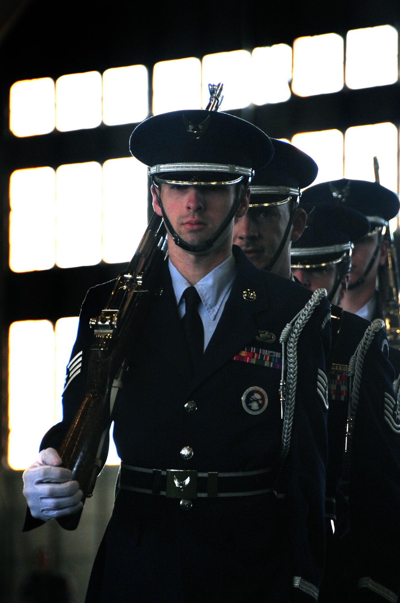 ELLSWORTH AIR FORCE BASE, S.D. -- Airmen of the Ellsworth Honor Guard march out after posting the colors at the Pride Hangar for the Kids, Spouses and Teachers Understanding Deployment Operations event, March 13.  Airmen and families recited the Pledge of Allegiance before the posting of the colors. (U.S. Air Force photo/Airman 1st Class Anthony Sanchelli)