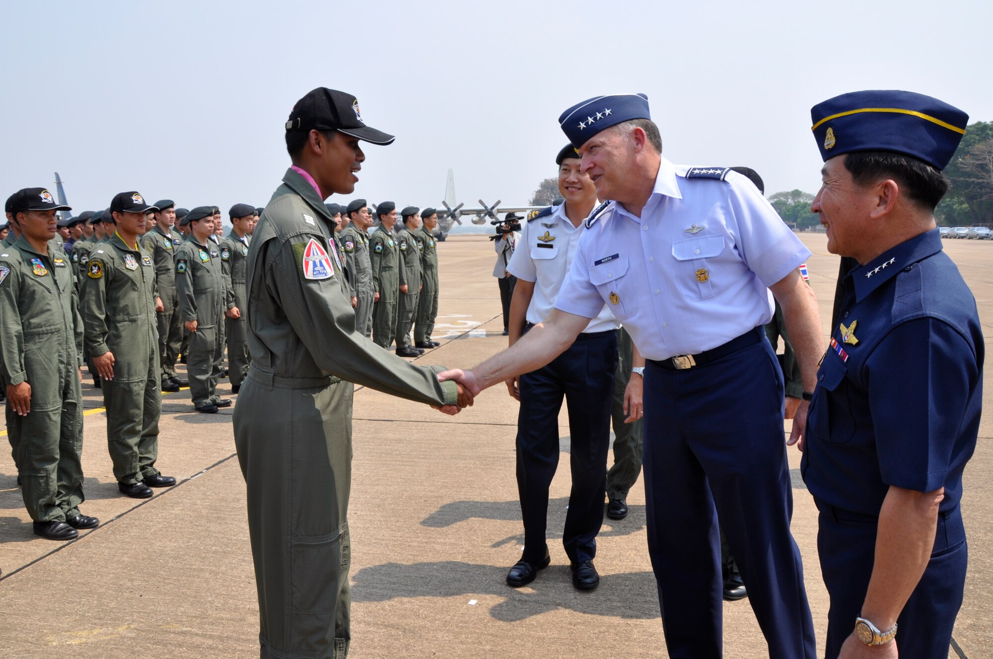 Gen. Gary North, Pacific Air Forces commander, greets the commander of troops for the Republic of Singapore Air Force during the Cope Tiger 2010 closing ceremony March 12 at Korat Royal Thai Air Force Base, Thailand.  Air Chief Marshal Itthaporn Subhawong, Royal Thai Air Force commander in chief (right), presided over the ceremony. Cope Tiger is an annual multilateral exercise involving the U.S., Singaporean and Thai air forces. The exercise is designed to enhance combined readiness and interoperability, and demonstrates U.S. commitment to the Asia-Pacific region. (U.S. Air Force photo/Capt. Christy Stravolo)