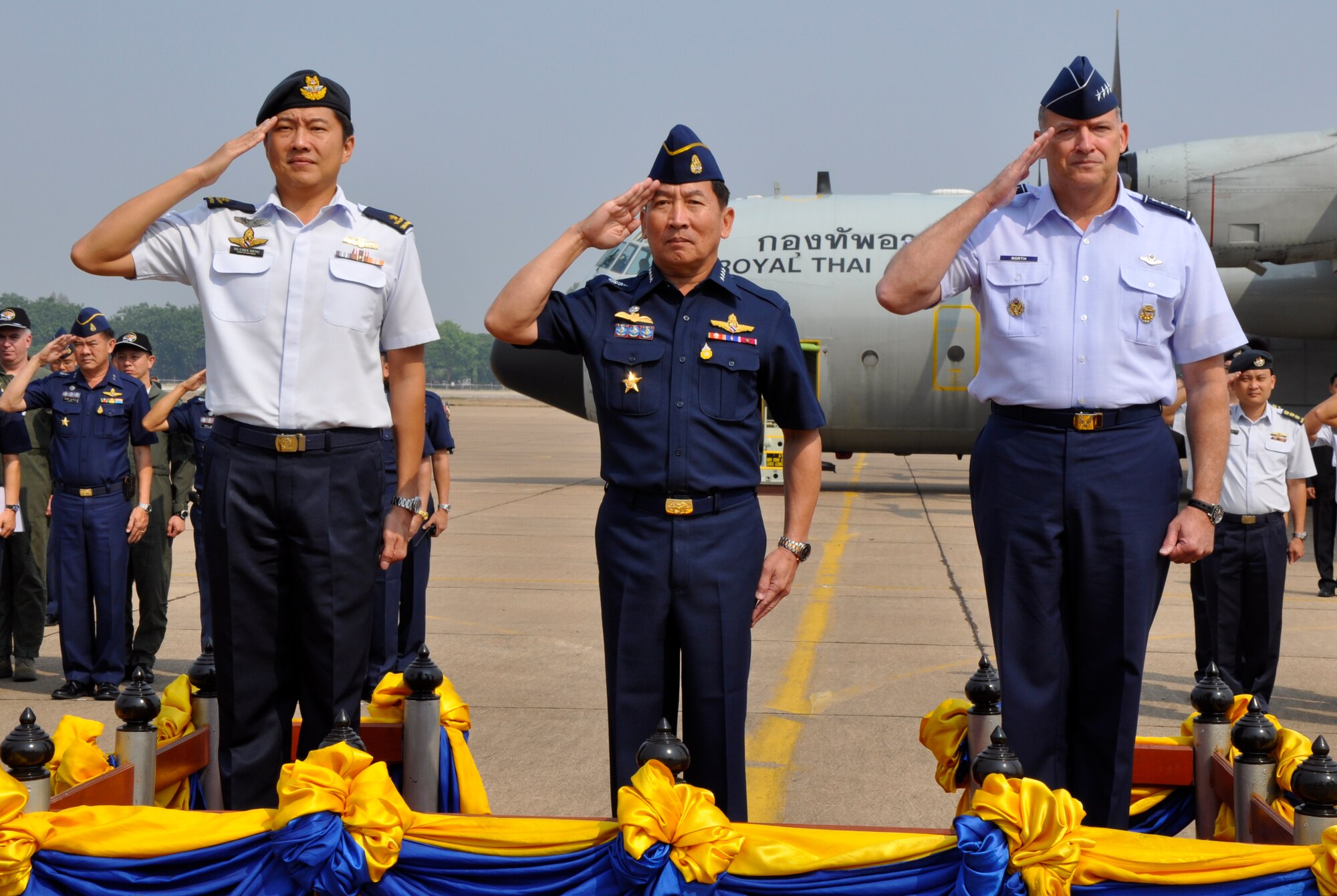 Brig. Gen. Ng Chee Meng, Republic of Singapore Air Force chief of air force; Air Chief Marshal Itthaporn Subhawong, Royal Thai Air Force commander in chief; and Gen. Gary North, Pacific Air Forces commander, salute as the Thailand national anthem is played during the Cope Tiger 2010 closing ceremony at Korat Royal Thai Air Force Base, Thailand, March 12.  Cope Tiger is an annual multilateral exercise that enhances combined readiness and interoperability, and demonstrates U.S. commitment to the Asia-Pacific region. (U.S. Air Force photo/Capt. Christy Stravolo)