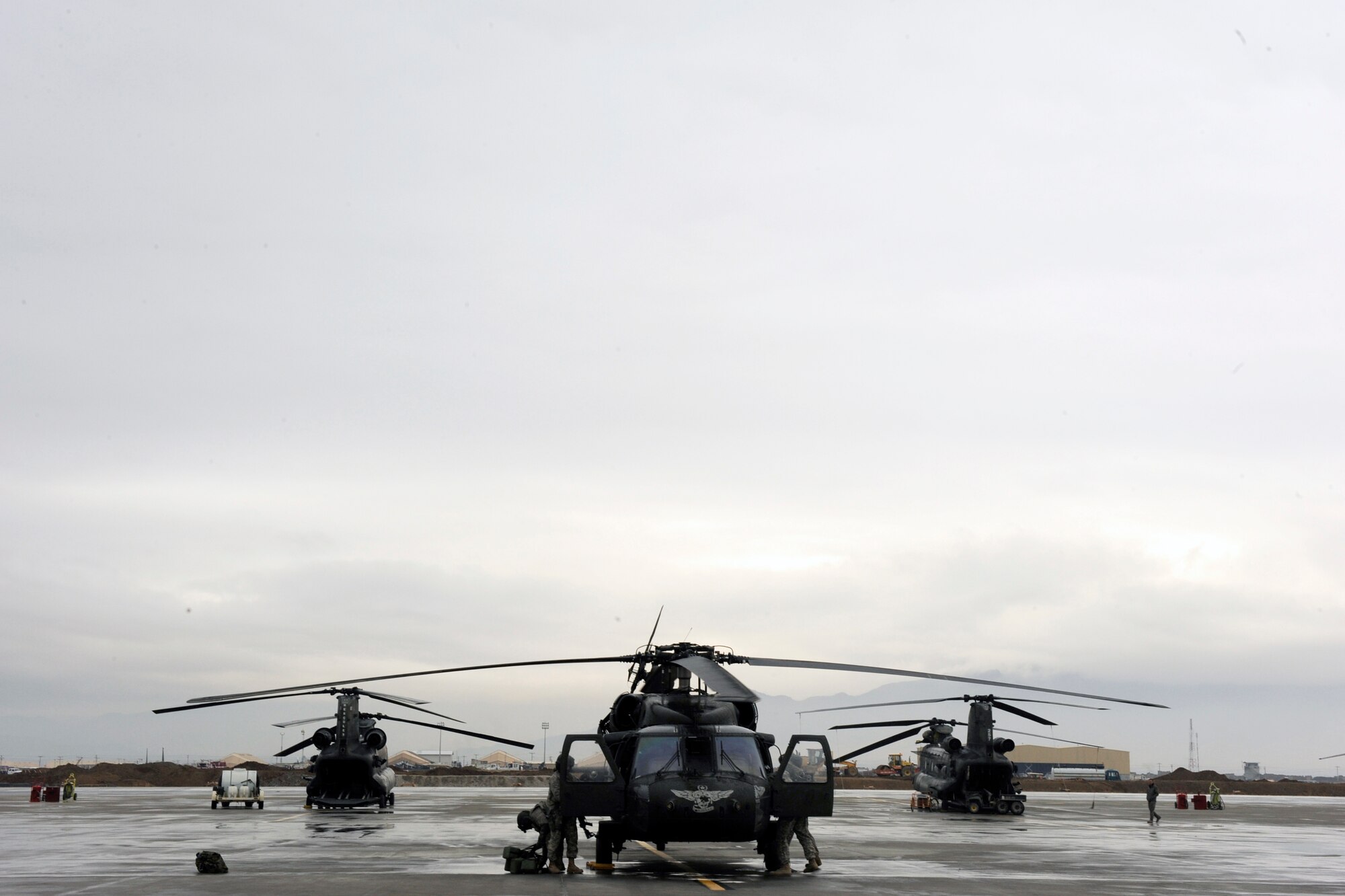 A UH-60 Blackhawk aircrew prepares a helicopter for a proficiency training flight for Afghanistan National Army Air Corp (ANAAC) crew chief students to apply lessons taught to them by A joint team of Airmen from the 440th Air Expeditionary Advisory Squadron and Soldiers from the 3rd Combat Aviation Brigade, Task Force Falcon, Feb. 28, 2010 at Bagram Airfield, Afghanistan. Though the ANAAC soldiers will primarily use their new skills aboard their country's military helicopter, the MI-17, training aboard an UH-60 Blackhawk proved to be a unique and rewarding experience. (U.S. Air Force photo/Staff Sgt. Manuel J. Martinez/released)
