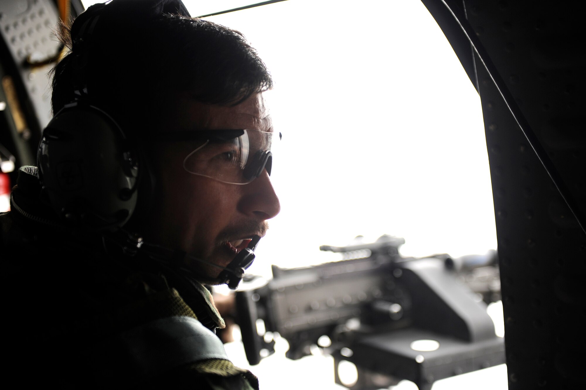Sergeant M-Yousaf Wafa, an Afghan National Army Air Corps crew chief, practices skills taught to him during his attendance of the Afghan National Security Forces Crew Chief Academy, during a flight on a UH-60 Blackhawk, Feb. 28, 2010, over Parwan Province, Afghanistan. A joint team of Airmen from the 440th Air Expeditionary Advisory Squadron and Soldiers from the 3rd Combat Aviation Brigade, Task Force Falcon, took Afghan Air Corpsmen to new heights by leading the first class of Afghans through the Afghan National Security Forces Crew Chief Academy (U.S. Air Force photo/Staff Sgt. Manuel J. Martinez/released)
