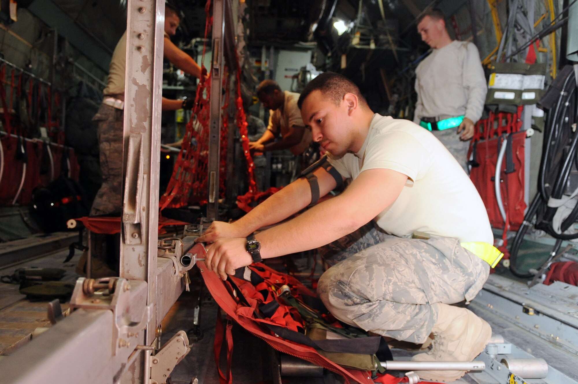 Airmen from the 777th Expeditionary Aircraft Maintenance Unit put seats in a C-130E to prepare it for its last combat mission at Joint Base Balad, Iraq, on March 6, 2010.  The aircraft has served in many different roles such as humanitarian missions, airlift transport of troops and equipment, and operations during Desert Storm.
.(U.S. Air Force photo/Senior Airman Brittany Y. Bateman/Released)
