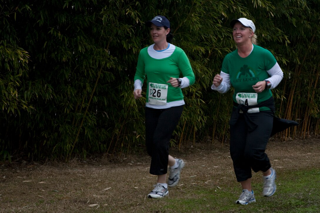 Sporting festive green, Andrea Smith and Alisa Hayes keep each other company on the first lap of the 5K run during the 2010 Run on the Green at Torii Pines golf course here March 13. Smith finished with a time of 31 minutes while Hayes came in shortly after at 32 minutes and 10 seconds.