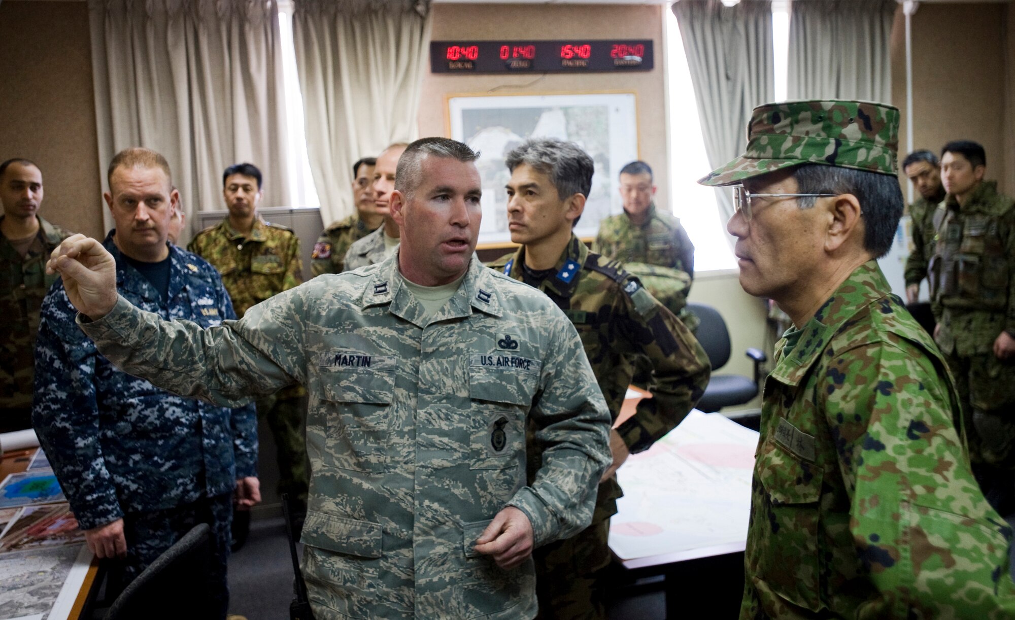 MISAWA AIR BASE, Japan -- Capt. Leo Martin, 35th Security Forces Squadron commander, discusses functions of the Combined Base Defense Operating Center to Lt. Gen. Kazuya Kayashi, Japan Ground Self-Defense Force 9th Division commander, March 12 during Exercise Guard and Protect. General Kayashi visited from Aomori, Japan, to witness the joint training amongst the 35th SFS, JGSDF 9th Division and Japan Air Self-Defense Force 3rd Air Wing. (U.S. Air Force photo/Senior Airman Jamal D. Sutter)