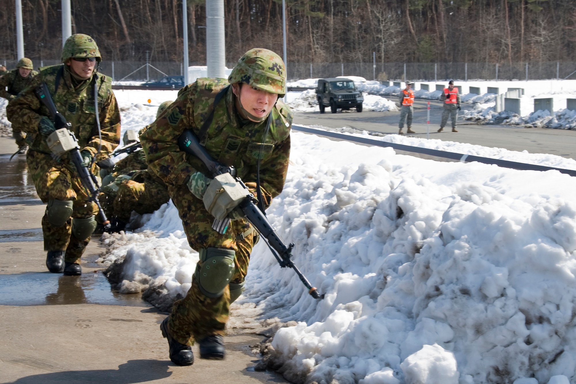 MISAWA AIR BASE, Japan -- Members of the Japan Ground Self-Defense Force 9th Division, 5th infantry Regiment, respond to a simulated security breach March 12 during Exercise Guard and Protect. During the exercise, the JGSDF partnered with the 35th Security Forces Squadron and Japan Air Self-Defense Force 3rd Air Wing to train against unauthorized entries, improvised explosive devices and probing by adversaries. (U.S. Air Force photo/Senior Airman Jamal D. Sutter)